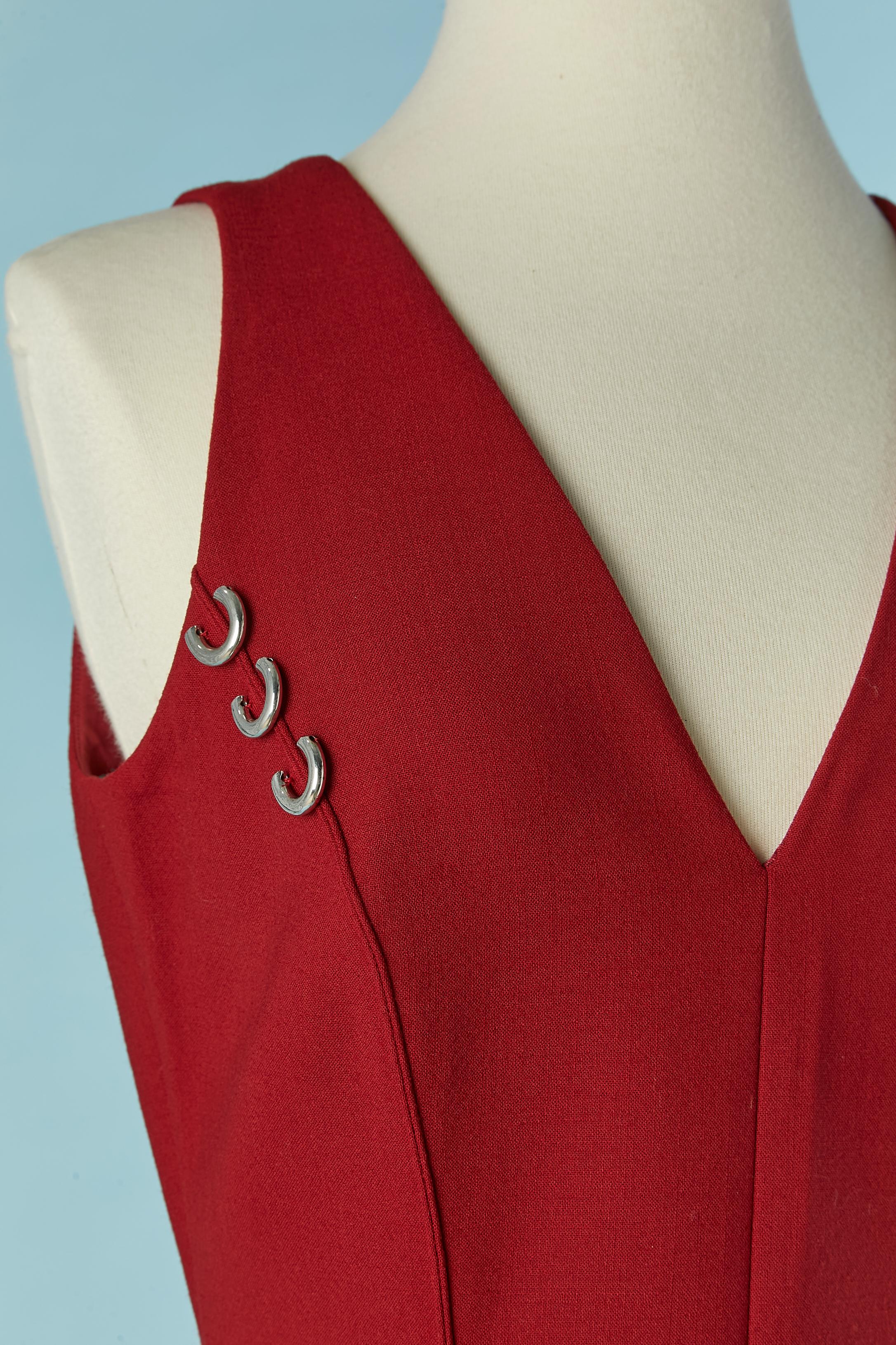 Sleeveless burgundy dress with metal piercing embellishment. Shell fabric composition: 95% wool, 5% elastane. 
Lining composition: 68% acetate, 32% polyester. 
Invisible zip closure on the middle back. 
SIZE 38 (Fr) M 