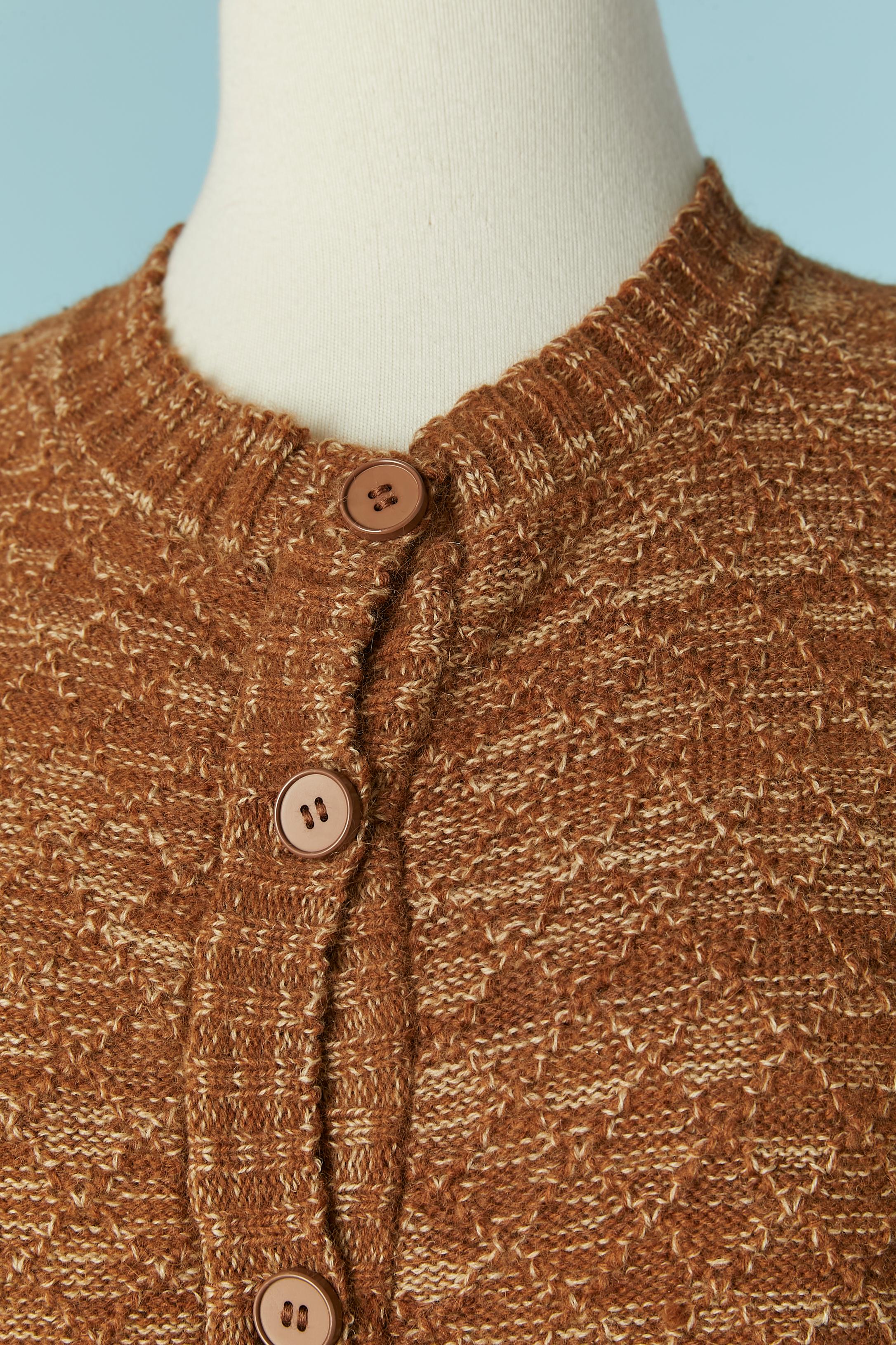 Sleeveless cardigan with fur around the head sleeve. Button and buttonhole closure on the middle front + pocket on both side. 
No knit composition tag but it's probably a mix of wool and angora and the fur is probably fox.
SIZE M/L 