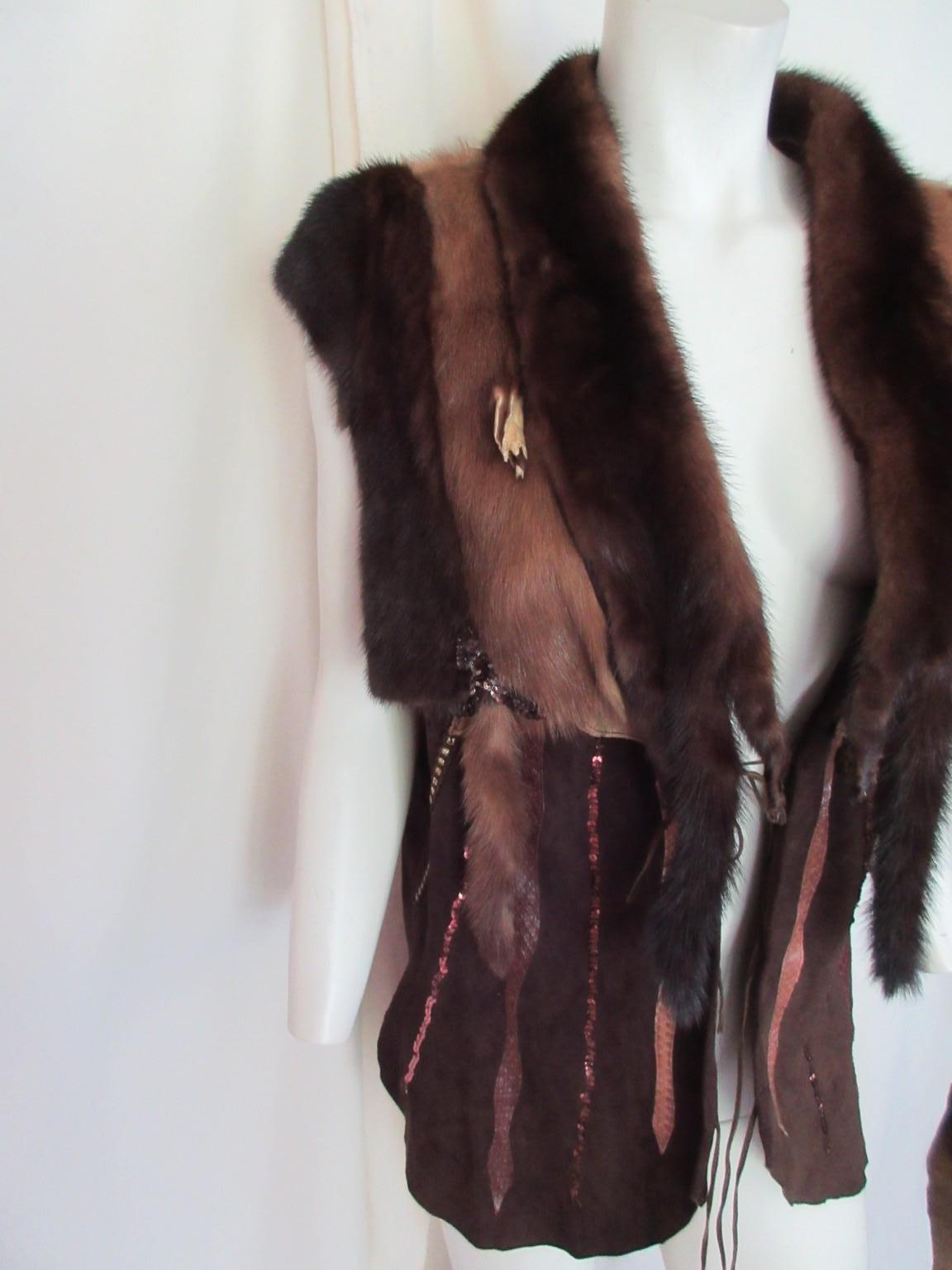 This vintage hippy style brown mink fur and suede vest embroidered with exotic details

We offer more exclusive vintage fur items, view our frontstore

Details:
Soft suede leather
Mink fur details
one leather fringe closing
no lining and no