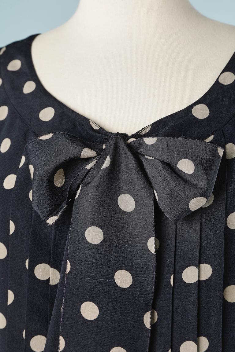 Sleeveless silk polka-dots top with bow in front  and buttons in the middle back.Pleated in the front. 
SIZE 36 (S) 