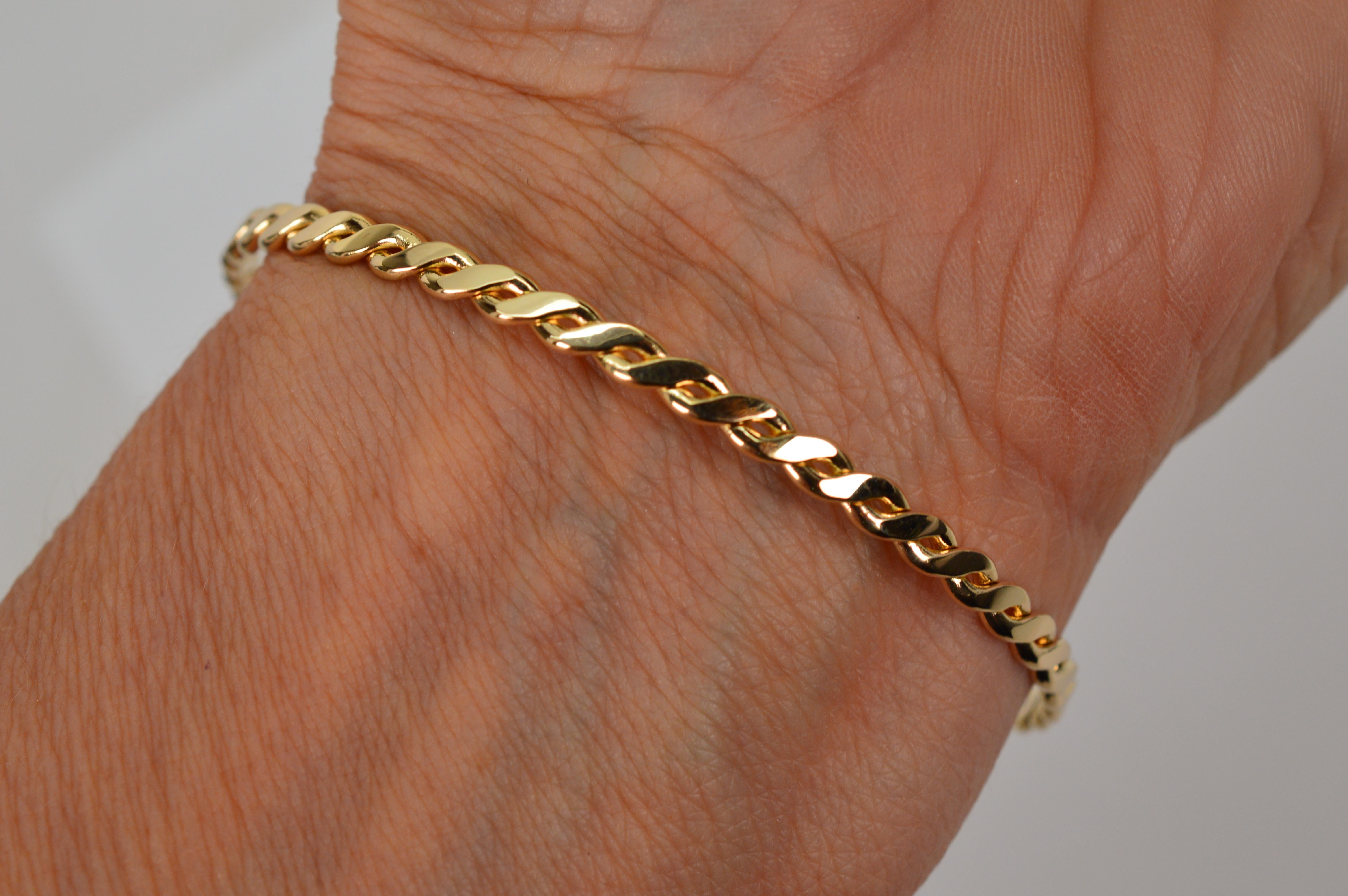 Women's Slender 14 Karat Yellow Gold Twist Bangle Bracelet For Sale