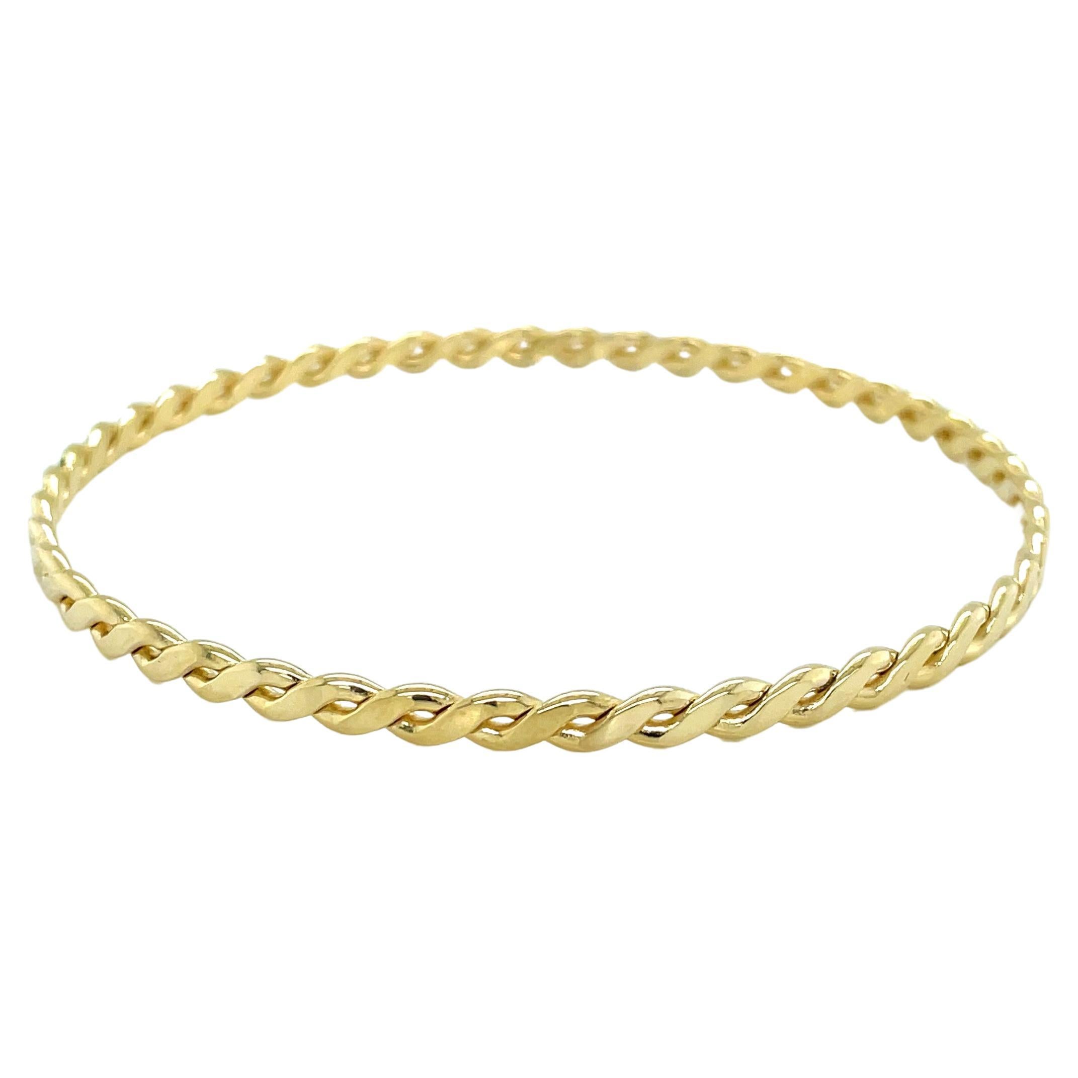 Slender 14 Karat Yellow Gold Twist Bangle Bracelet For Sale