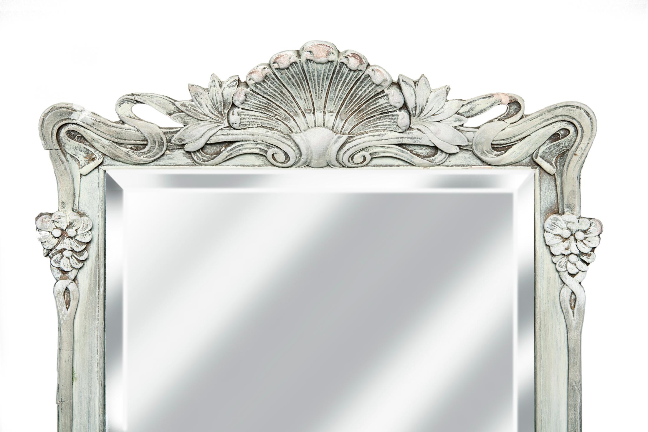 Art Nouveau artisan crafted frame/ fine beveled mirror. Elongated rectangle
older beveled mirror. Wired to hang with the crest on the top or bottom.