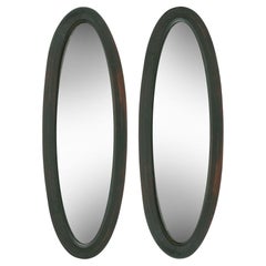 Slender Oval Beveled Mirrors in Ebony; a pair