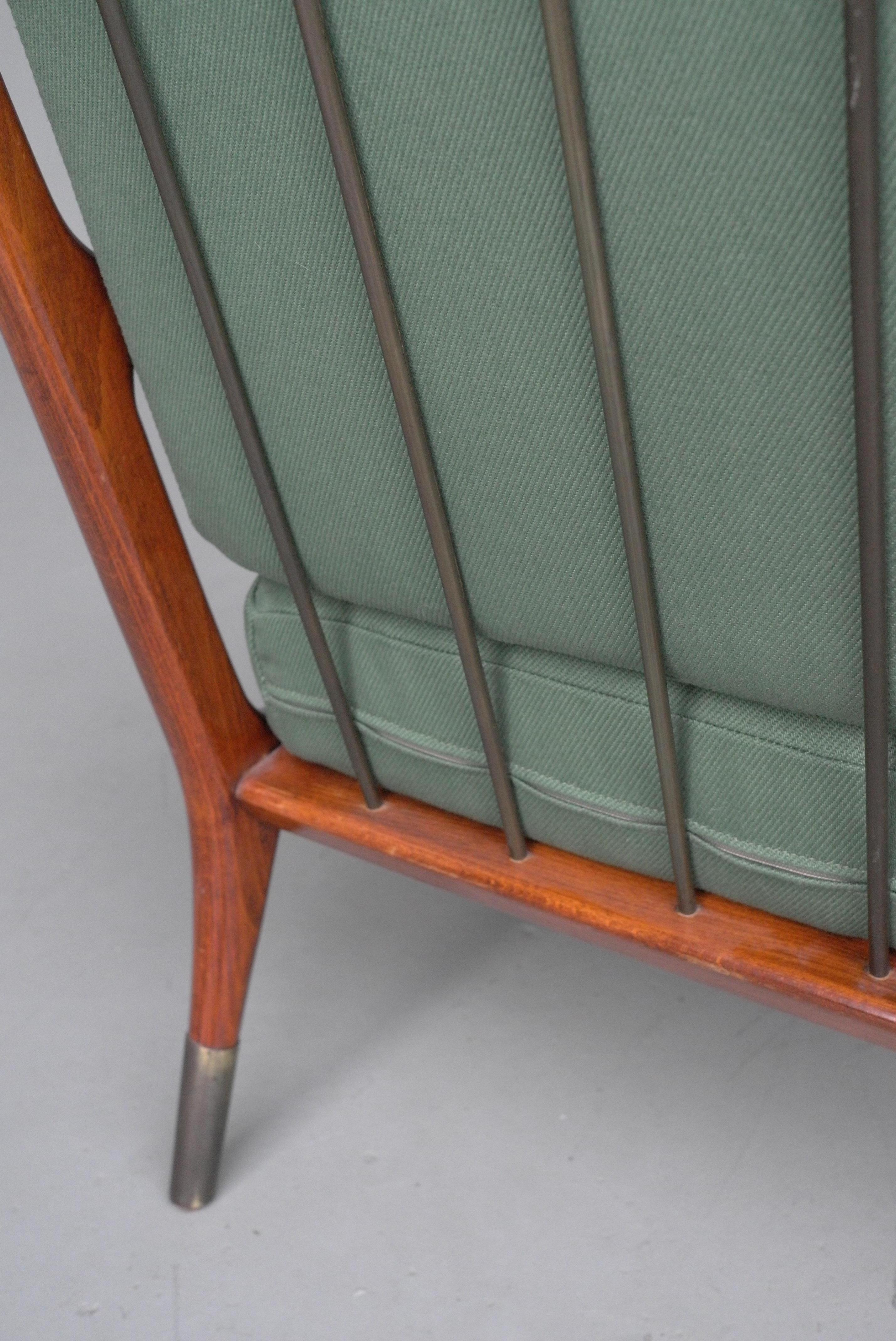 Slender wooden lounge chair with fine brass feet and brass bar back.

Recent newly upholstered in green fabric. Made in Italy, circa 1955.