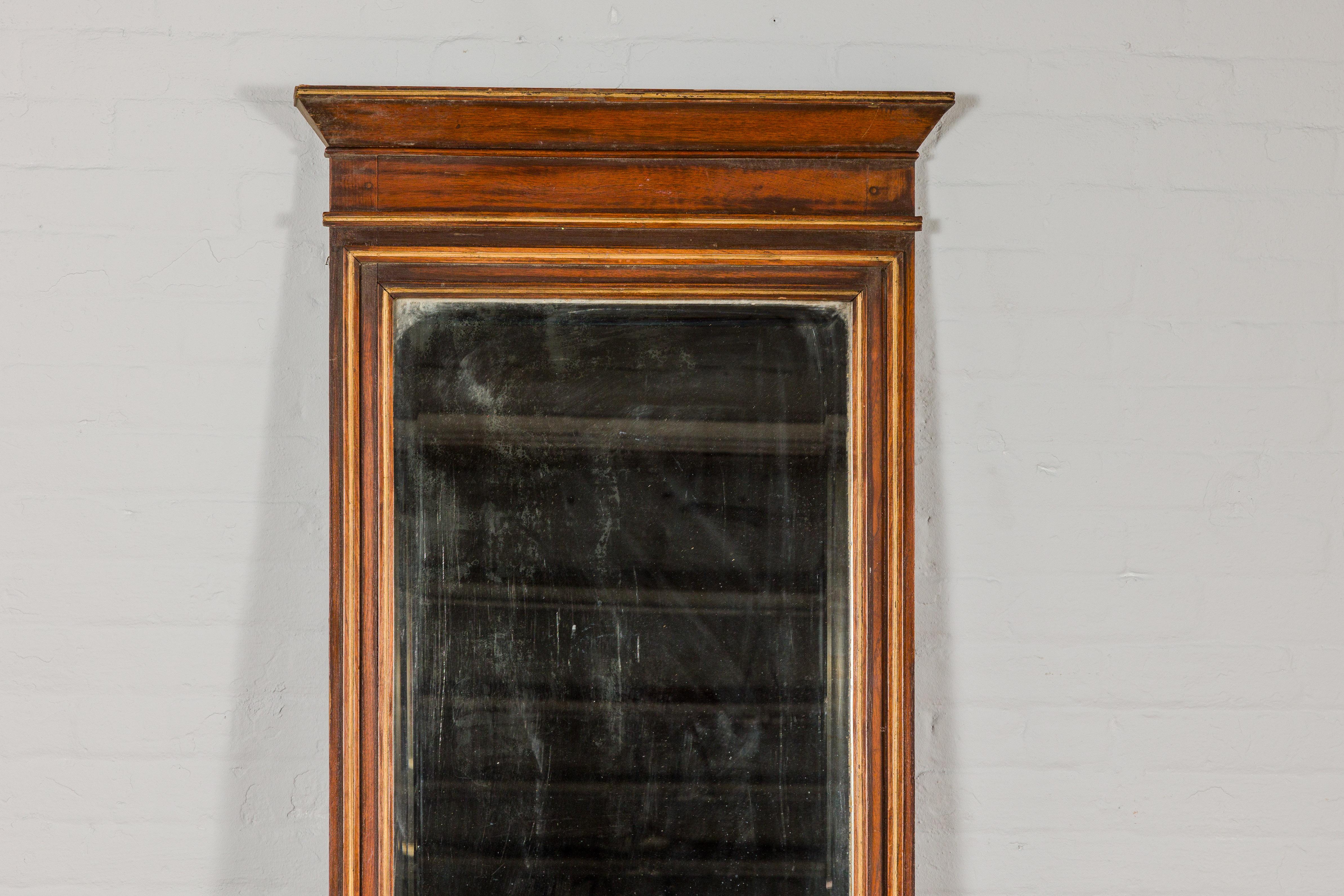 An antique Indian wooden frame made into a trumeau mirror. This antique Indian wooden frame transformed into a trumeau mirror epitomizes understated elegance. Its design is a harmonious blend of simplicity and sophistication, making it a versatile