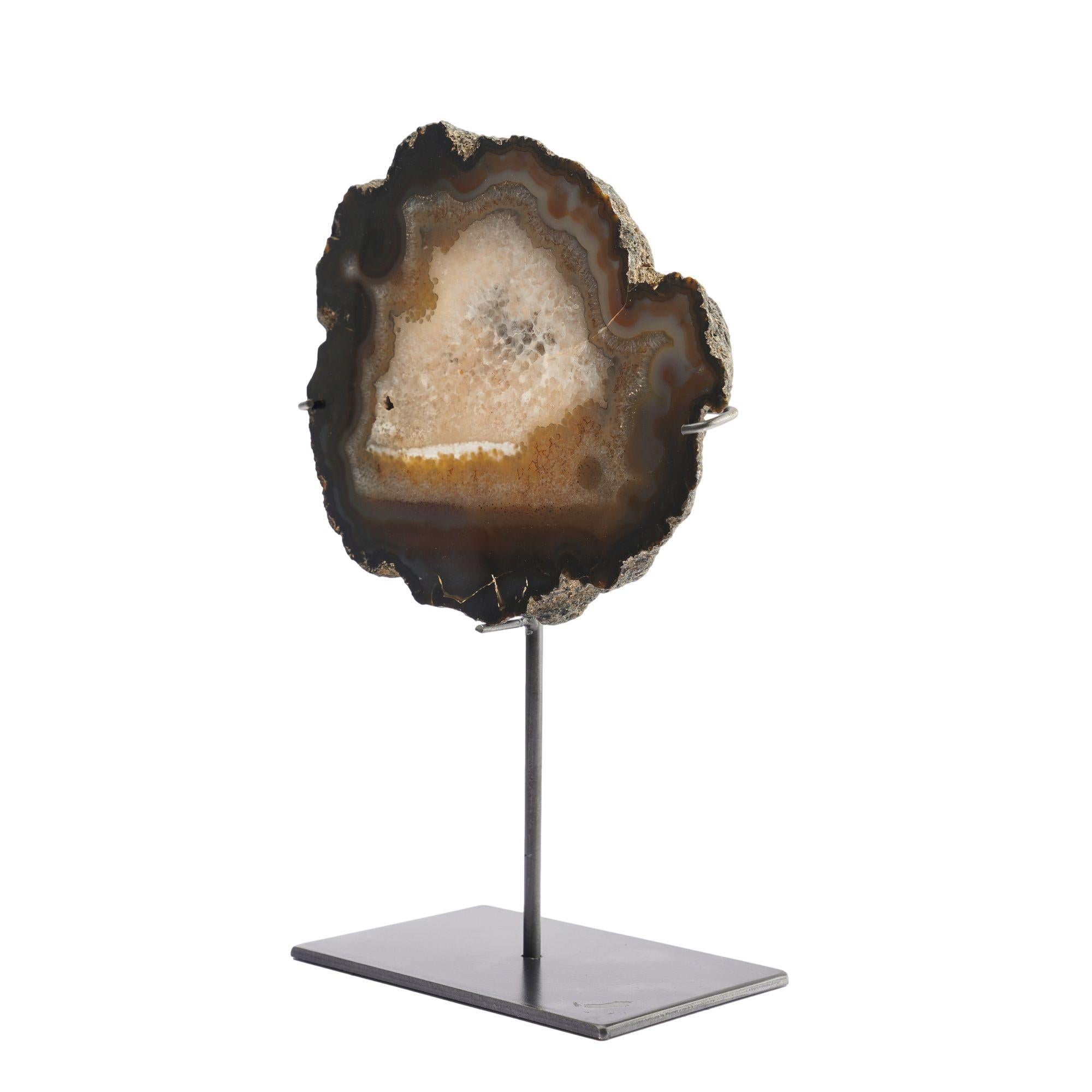 Slice cut agate geode specimen from Botswana in shades of brown and white, mounted on a custom stand.