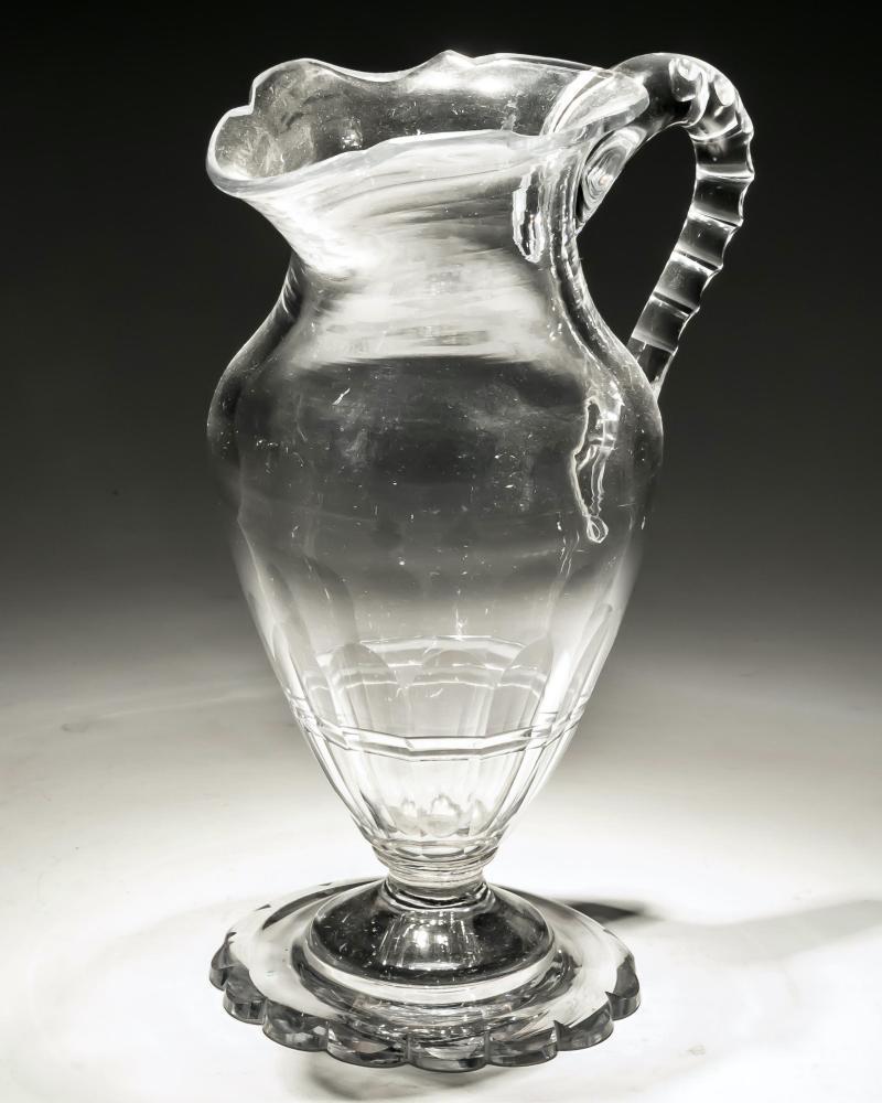 A pedestal footed slice cut petal edged Georgian jug with notched handles

England, circa 1780.

Measures: height: 19 cm (7 1/2