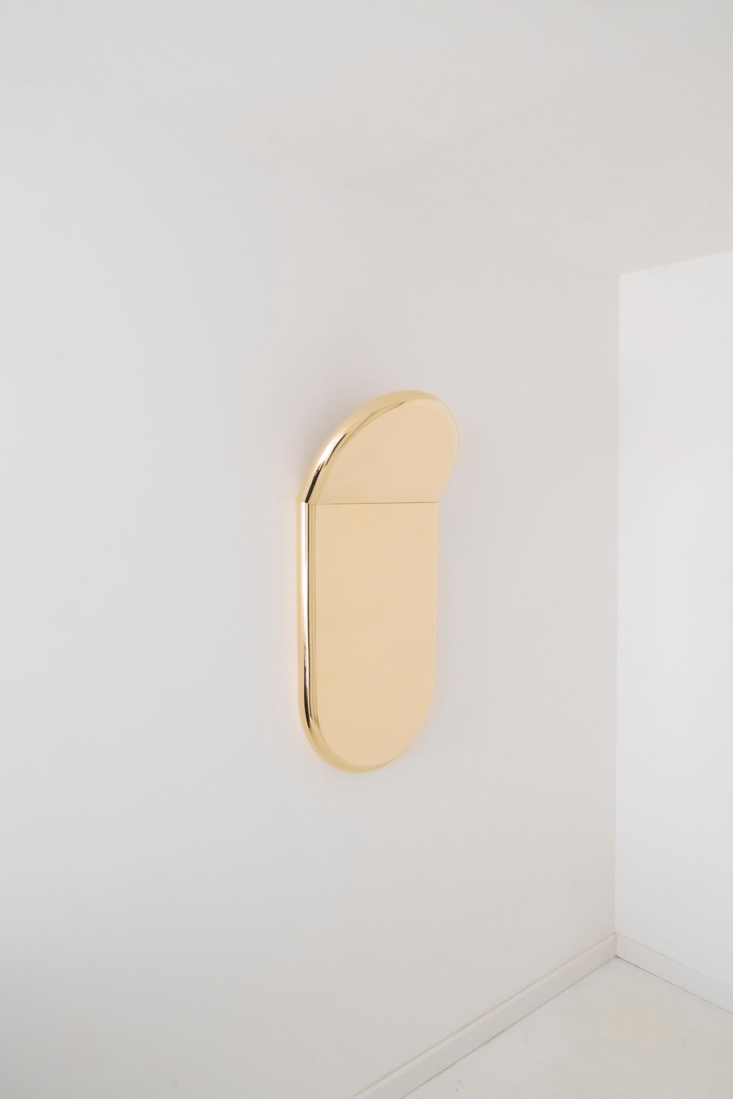 Slice wall mirror by Helder Barbosa
Materials: Polished brass
Dimensions: 83 x 40 x 5 cm

Trained as a craftsman (école Boulle, 2014), Helder Barbosa is a designer who lives and works in Paris.
Attracted by minimalist shapes, he creates