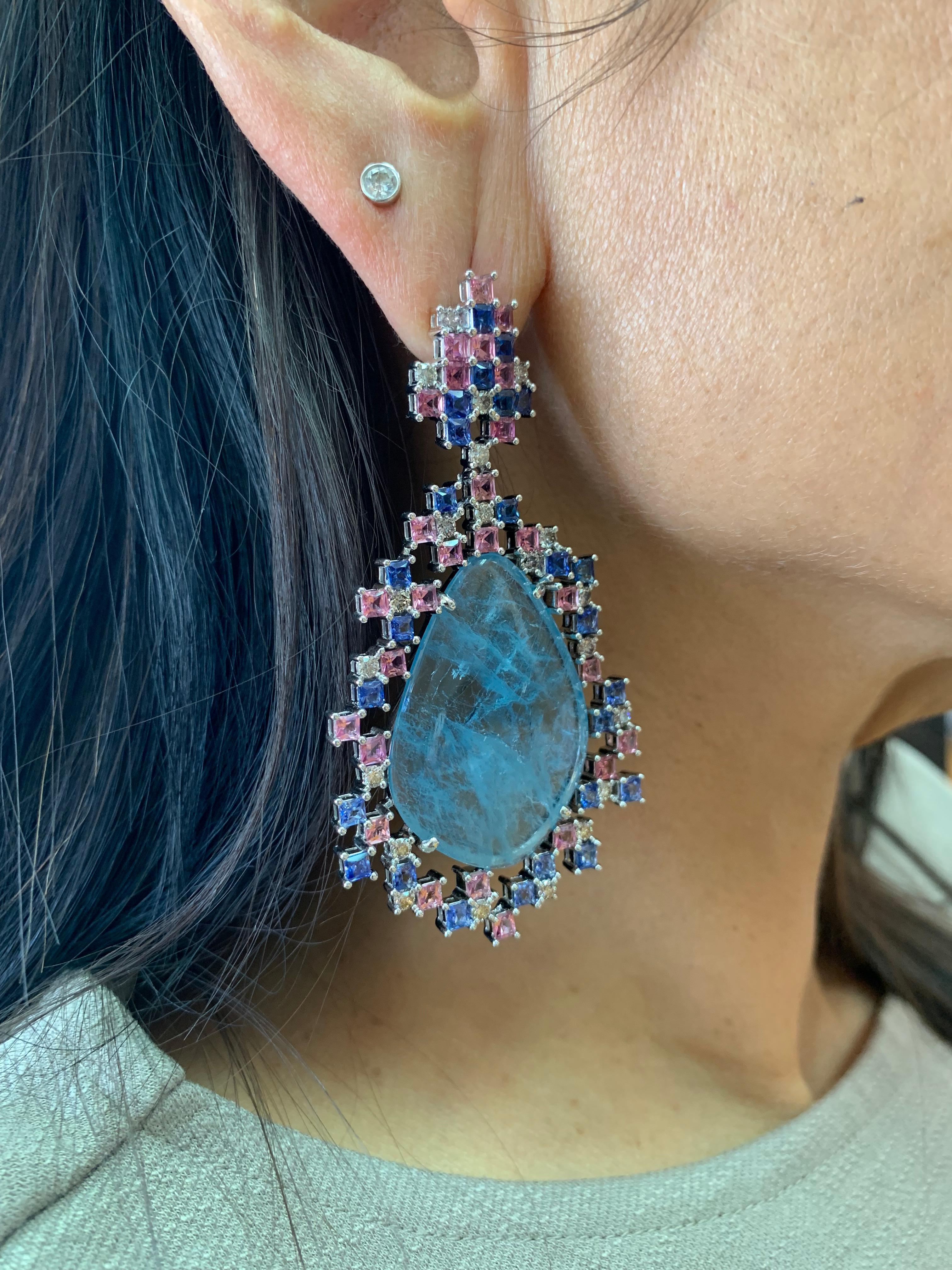 This is unique one-of-one earring incorporating sliced aquamarines with a pixelated design using pink tourmaline and blue sapphire. 

Sliced Aquamarine Earrings with Gemstone & Diamond in 18 Karat White Gold

Aquamarine: 37.28 carats, fancy sliced