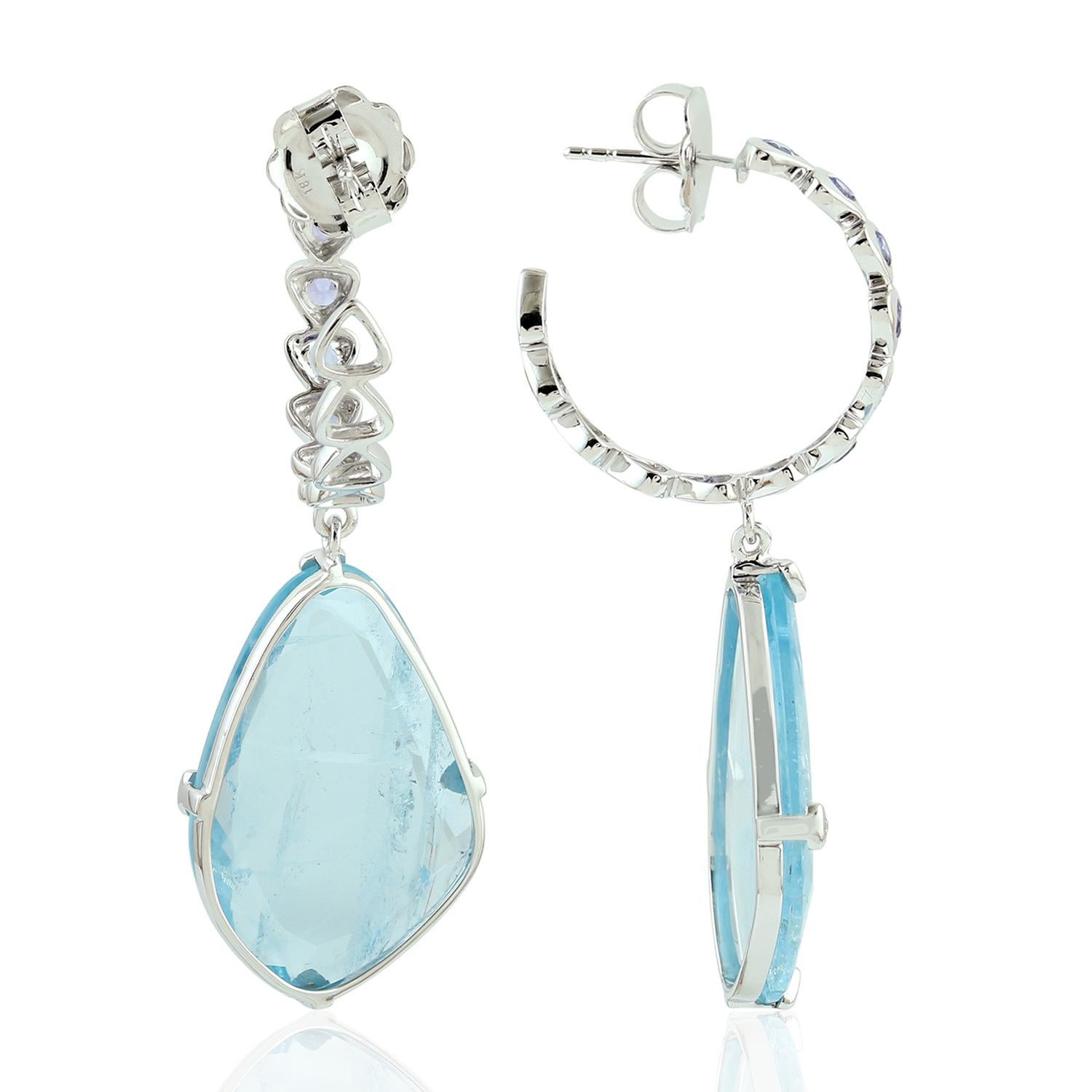 Sweet and sassy this sliced aquamarine earring with bezel set Tanzanite hoop on top is chic in 18K white gold.

Closure: Push Post

18KT: 9.394gms
Diamond: 0.11cts
AQUAMARINE: 25.60cts
TANZANITE: 1.12cts
