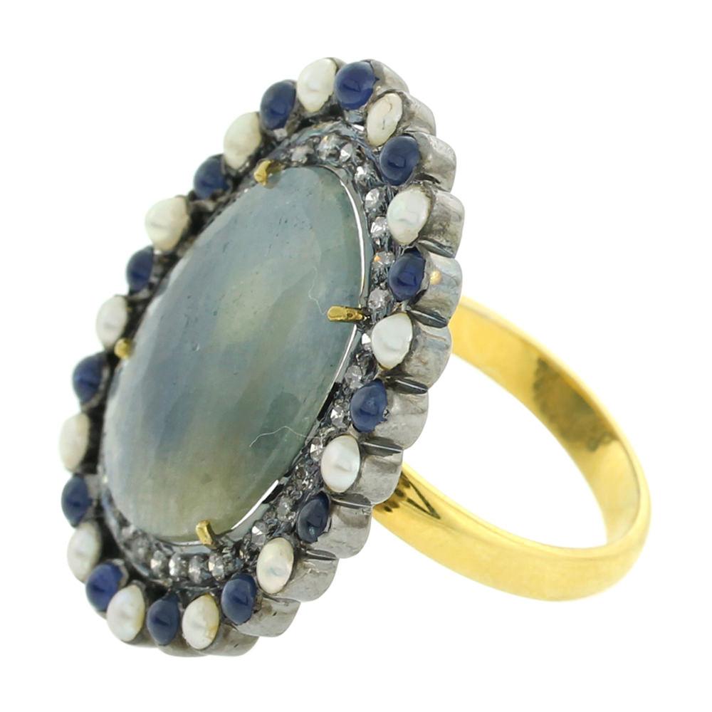 Stunning Sliced Blue Sapphire Ring with Diamonds and Pearls.

Ring Size 7 ( can be sized )

18k:3.29g,D:0.4ct
SAPPHIRE MULTI: 9.2Cts
PEARL:1.41Cts,
SAPPHIRE BLUE:1.3Cts,