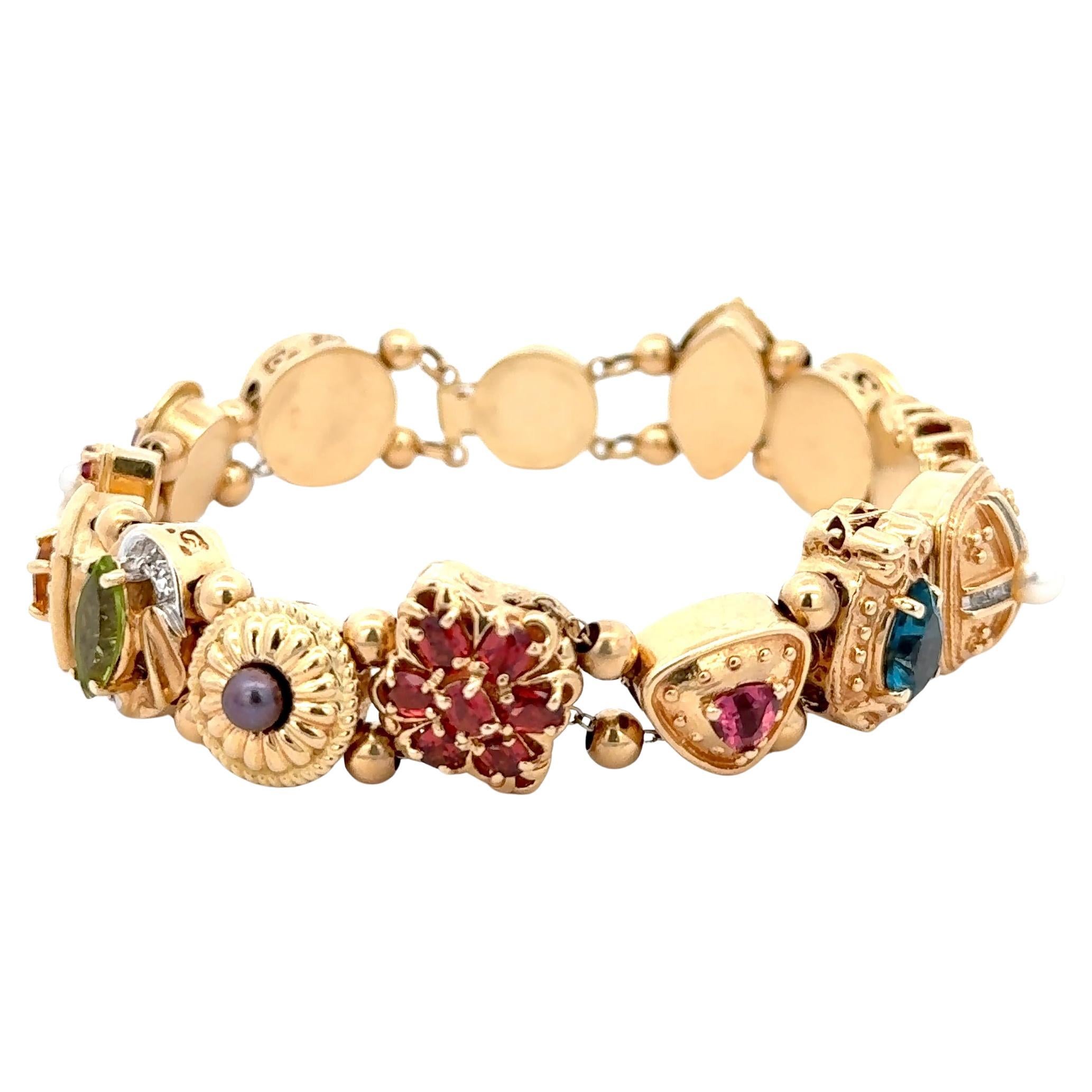 Slide Bracelet with Semi-precious Gemstones in 14K Yellow Gold. The bracelet features 13 charms. each with their own unique design. The bracelet is 7.5