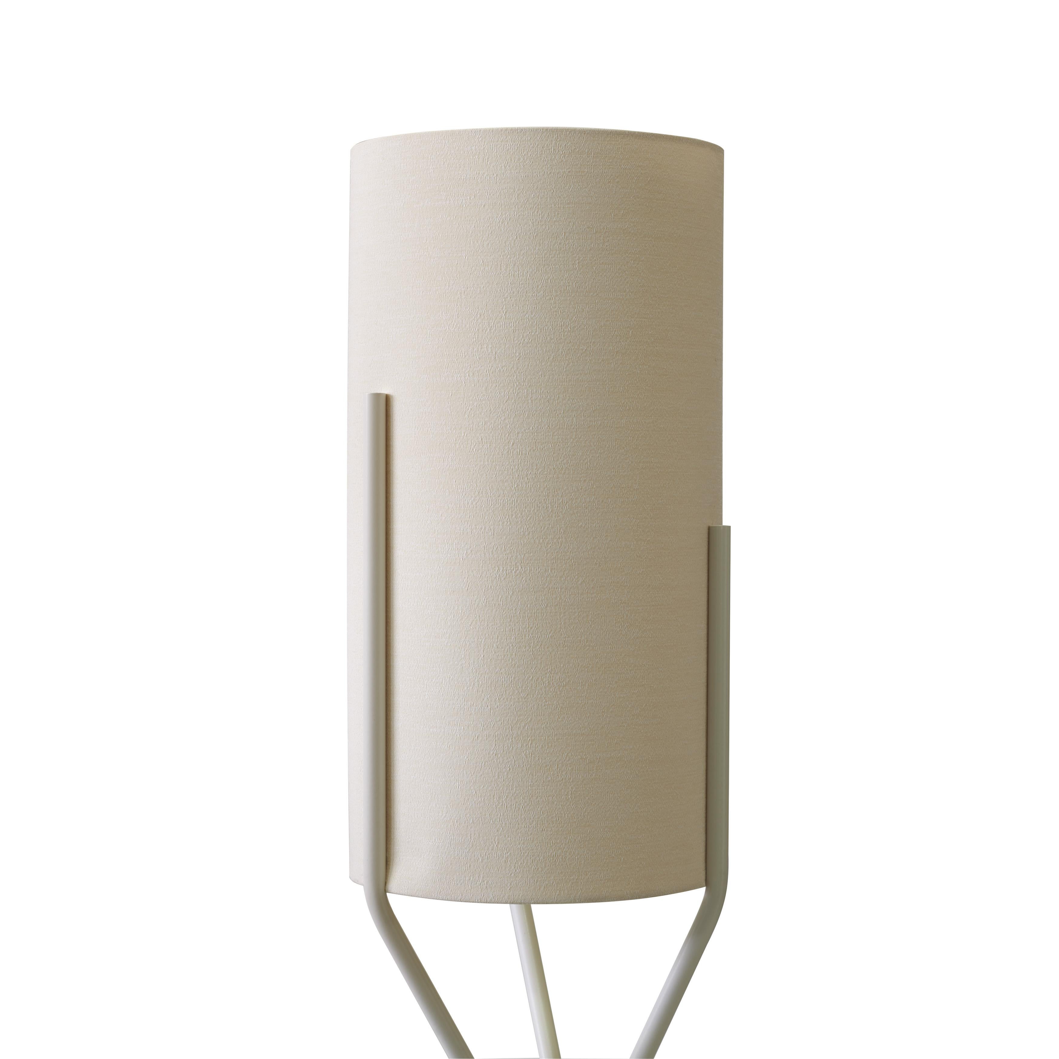 Three delicate embedded stems embrace a cylindrical lampshade: the result is Aura, the new floor lamp created by Ilaria Marelli. The stem is in painted iron, the lampshade in waterproof fabric, as this floor lamp is especially thought for an outdoor