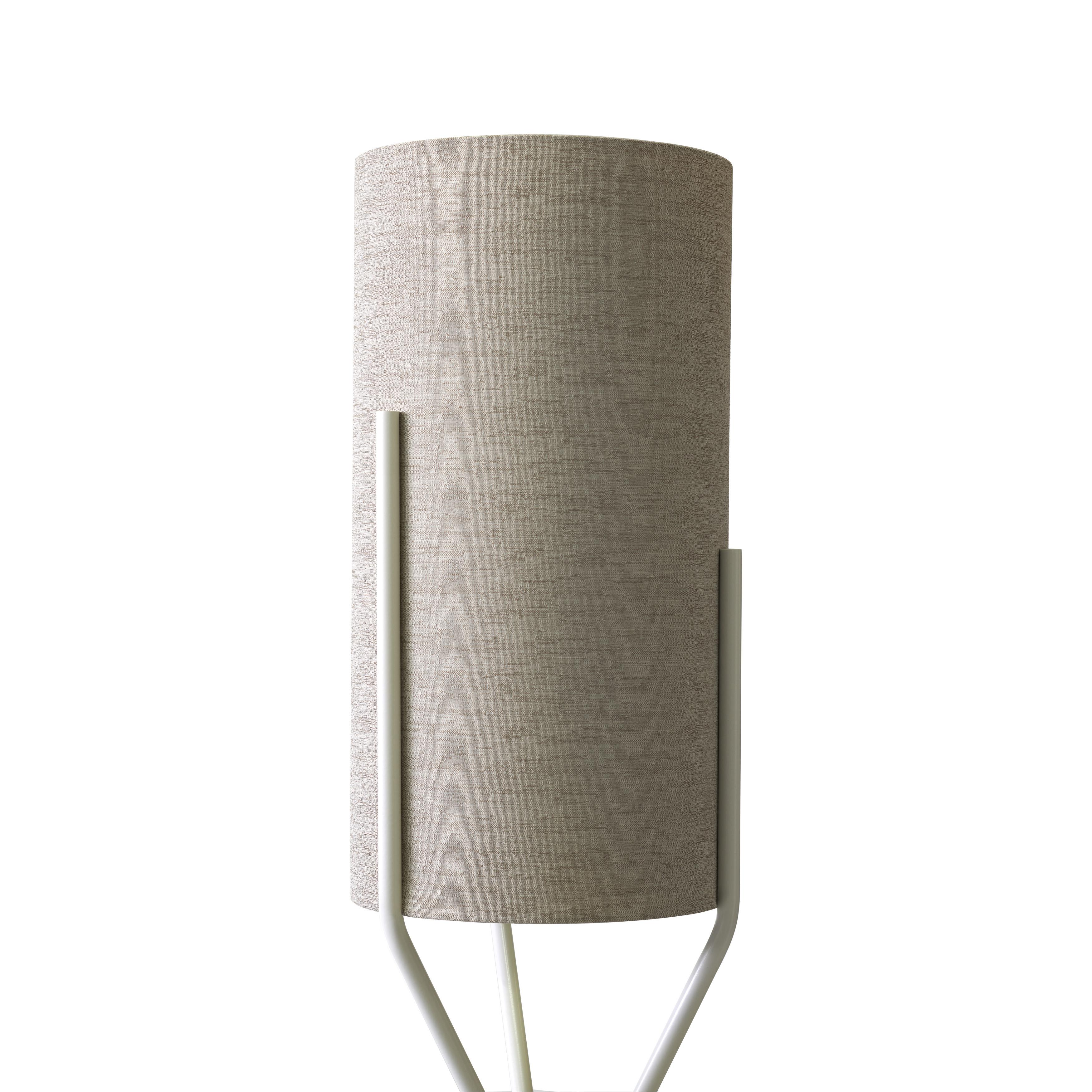 Three delicate embedded stems embrace a cylindrical lampshade: the result is Aura, the new floor lamp created by Ilaria Marelli. The stem is in painted iron, the lampshade in waterproof fabric, as this floor lamp is especially thought for an outdoor