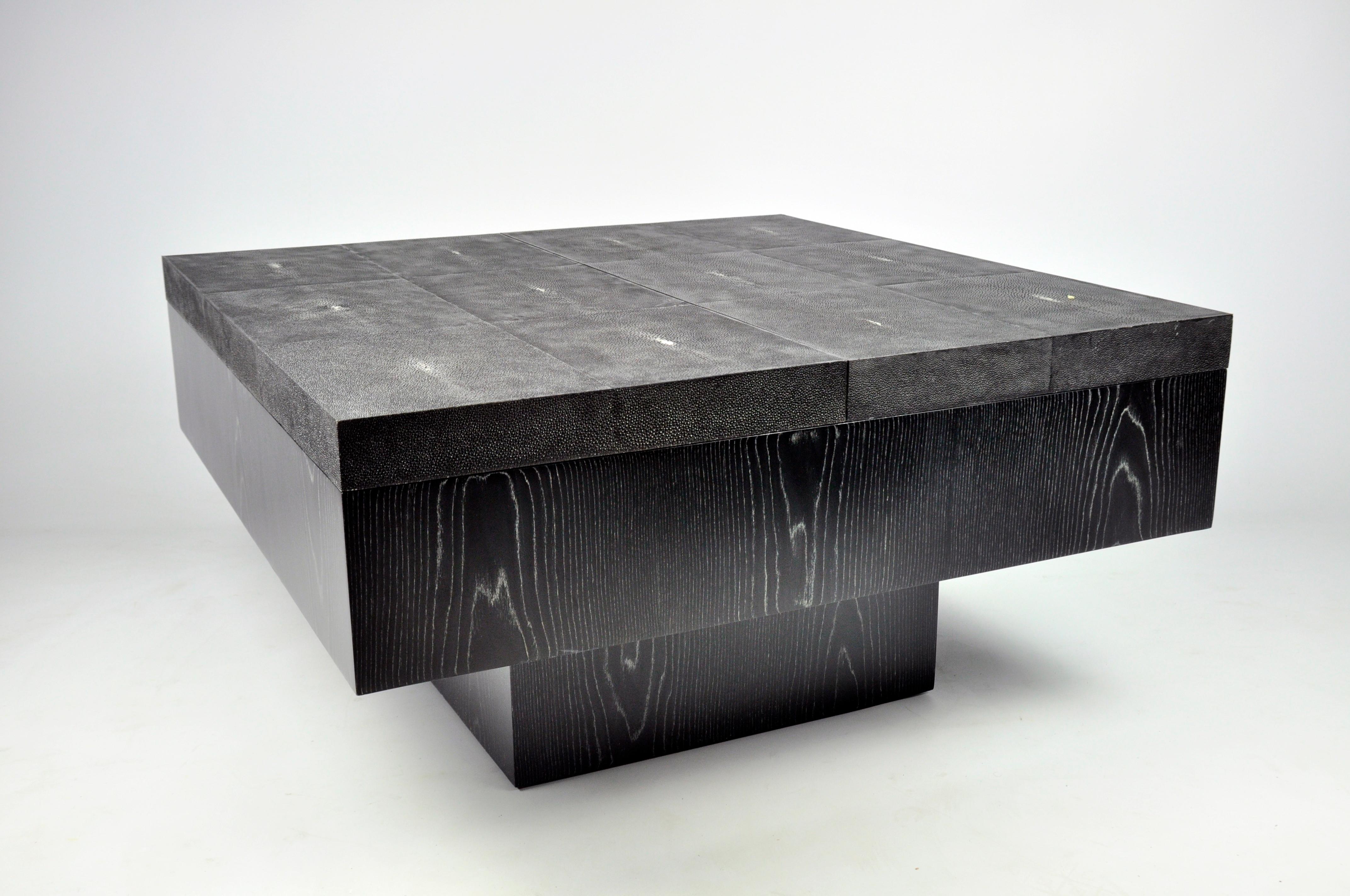 This coffee table is made for gamers.
It has a sliding top. When it's closed your can play cards and when it's opened you can play backgammon.
The table is made of shagreen and black and silver wood.

This piece when it's closed hide totally the
