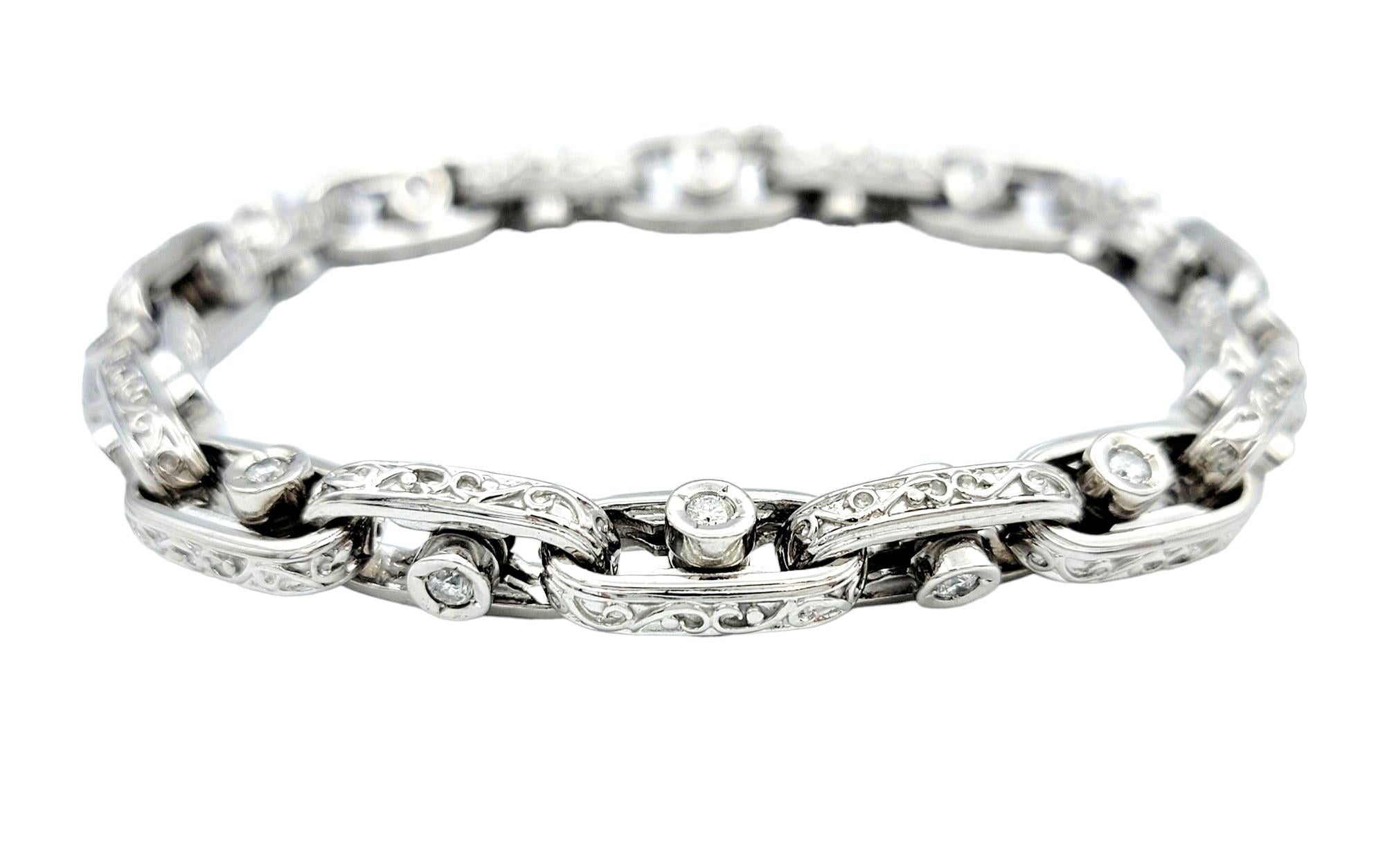 This chic bracelet, crafted in 14 karat white gold, is a dazzling expression of sophistication and ingenuity. Its design features large oval links, each adorned with a single sliding diamond that adds a dynamic and captivating element to the piece.