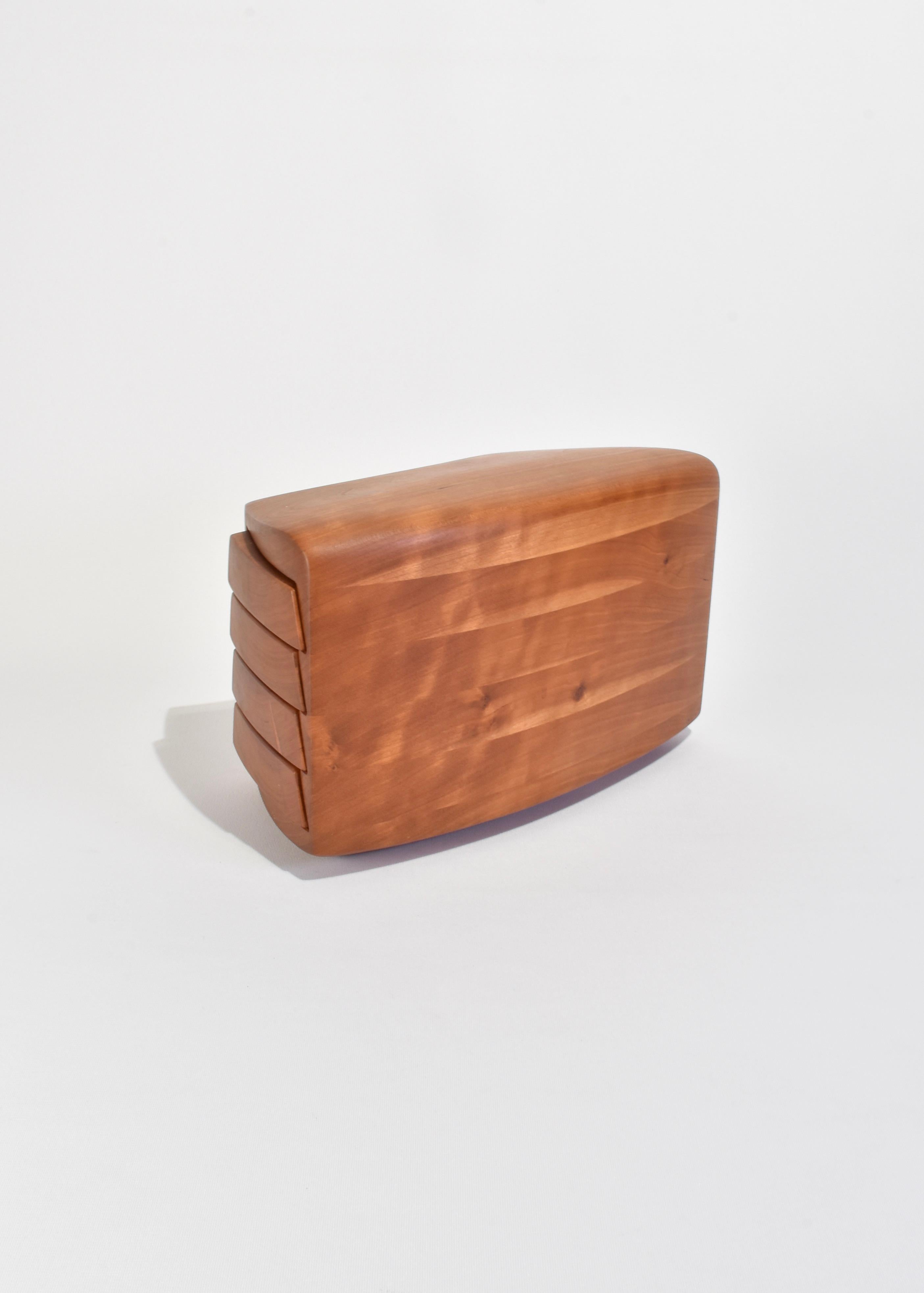 Stunning, sculptural wooden jewelry box with four sliding drawers lined in grey suede. Signed on base, Kellam '90.