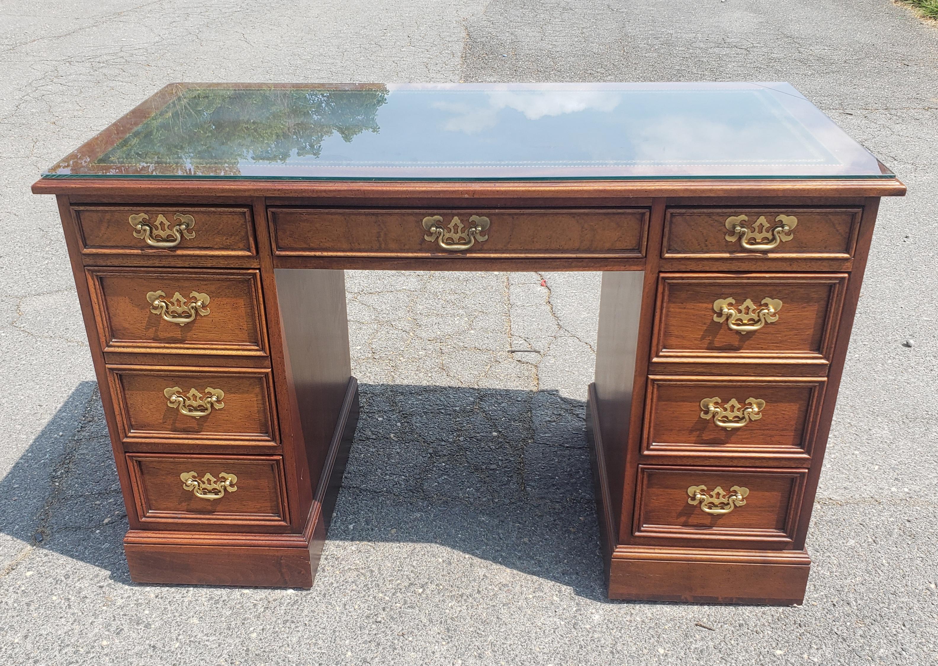 A Sligh Furniture Chippendale Mahogany and Tooled Leather Partners Desk with protective Glass top in great condition. 
All drawers with dovetail construction and working flawlessly.