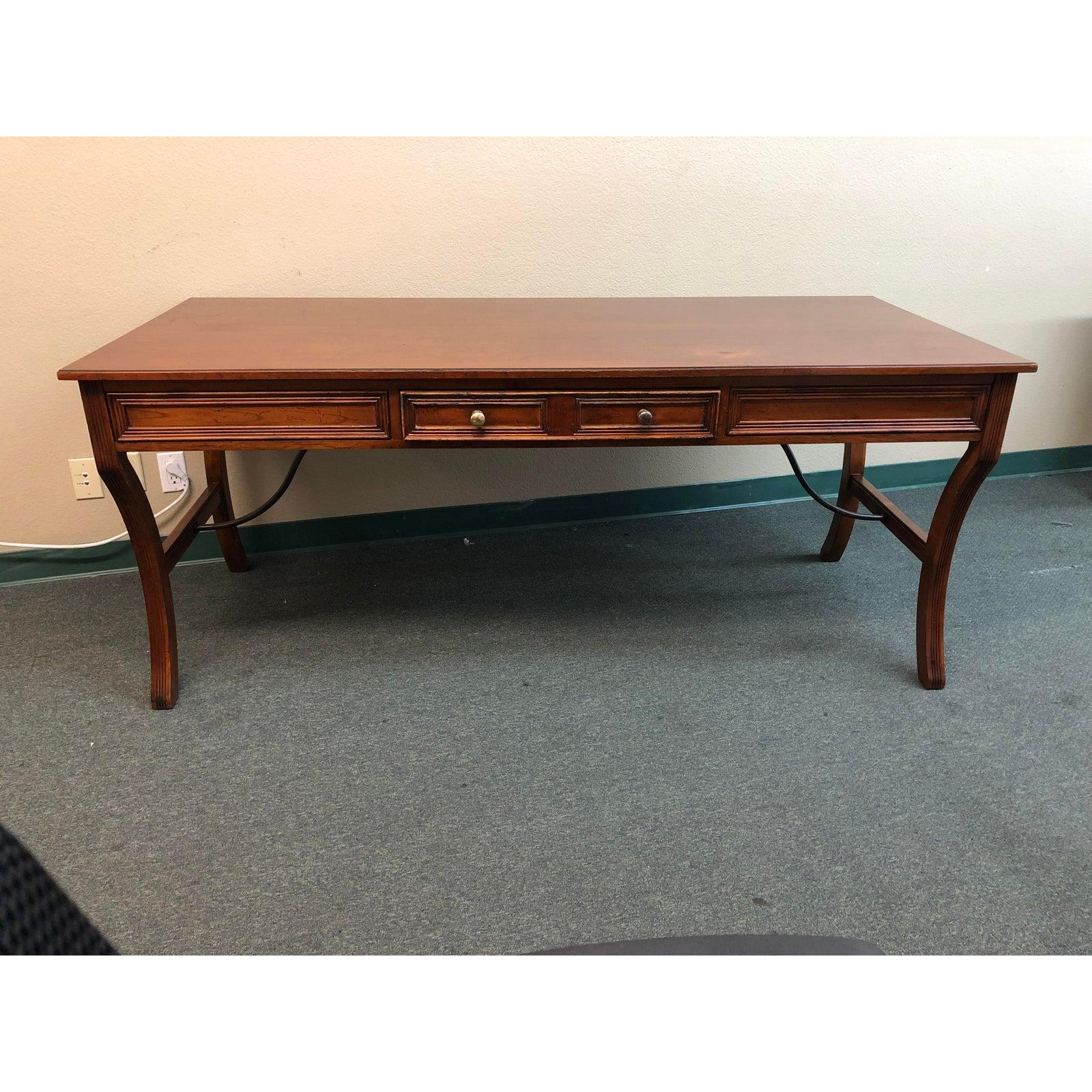 We presents wooden desk by Sligh. The desk has simple yet elegant lines. There is one middle drawer.