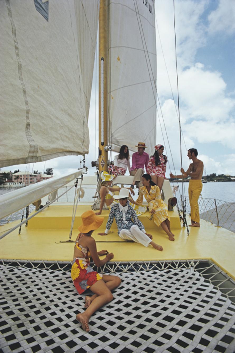 A Colourful Crew 
1970
by Slim Aarons

Slim Aarons Limited Estate Edition

A group of colourfully dressed friends on board the Calypso clothing store owned boat, Bermuda, June 1970.

unframed
c type print
printed 2023
20 × 16 inches - paper