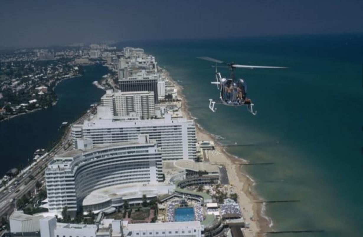 Aerial Miami Beach 
1972
by Slim Aarons

Slim Aarons Limited Estate Edition

 A helicopter carrying tourists hovers over the Fontainebleau Hotel on Miami Beach, Florida, April 1972.

unframed
c type print
printed 2023
16×20 inches - paper