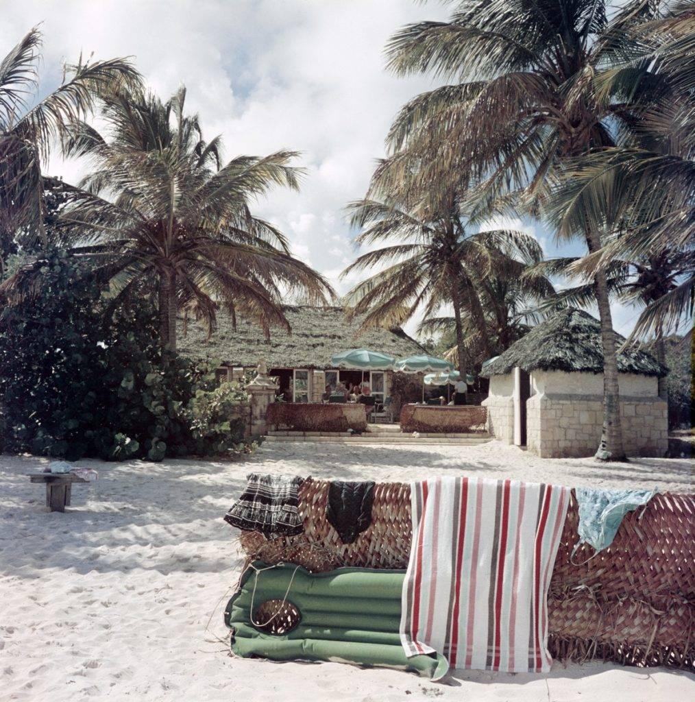 Slim Aarons Color Photograph - 'Antigua Beach Club' (Estate Stamped Edition)