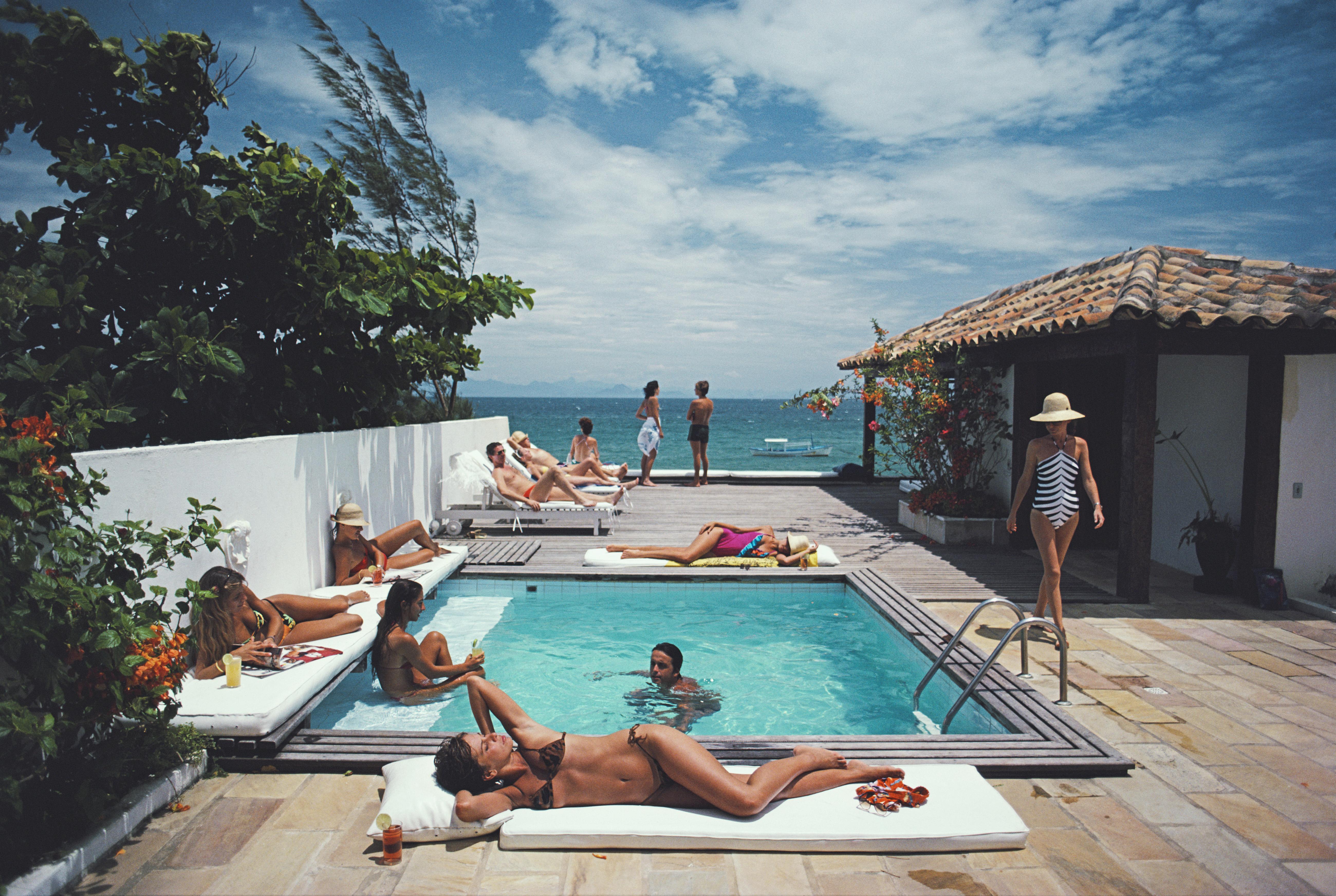 Slim Aarons Color Photograph - Armacao dos Buzios, Brazil, Estate Edition Photograph (Sunbathers, Ocean, Pool)