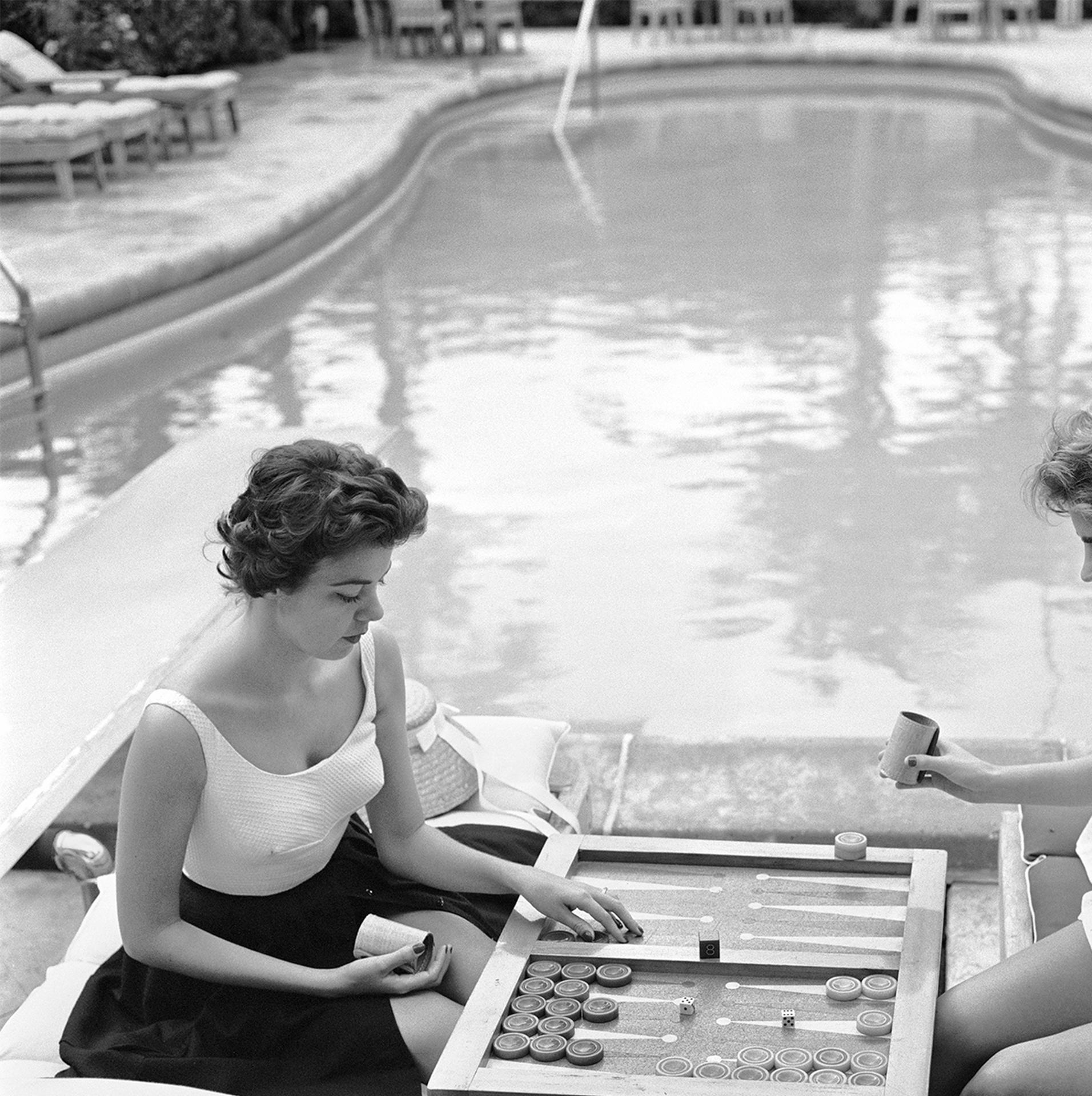 Dieses Porträtfoto des Society-Fotografen Slim Aarons aus den späten 1950er Jahren zeigt Gräfin Peters Jean-Baptiste de Manio (links) und Mary-Beth Turner beim Backgammon-Spielen an einem Swimmingpool in Palm Beach, Florida.

Dies ist eine