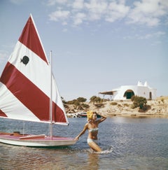 Retro Bettina Graziani with a small yacht, Costa Smeralda, Sardinia, Italy, Estate Ed.