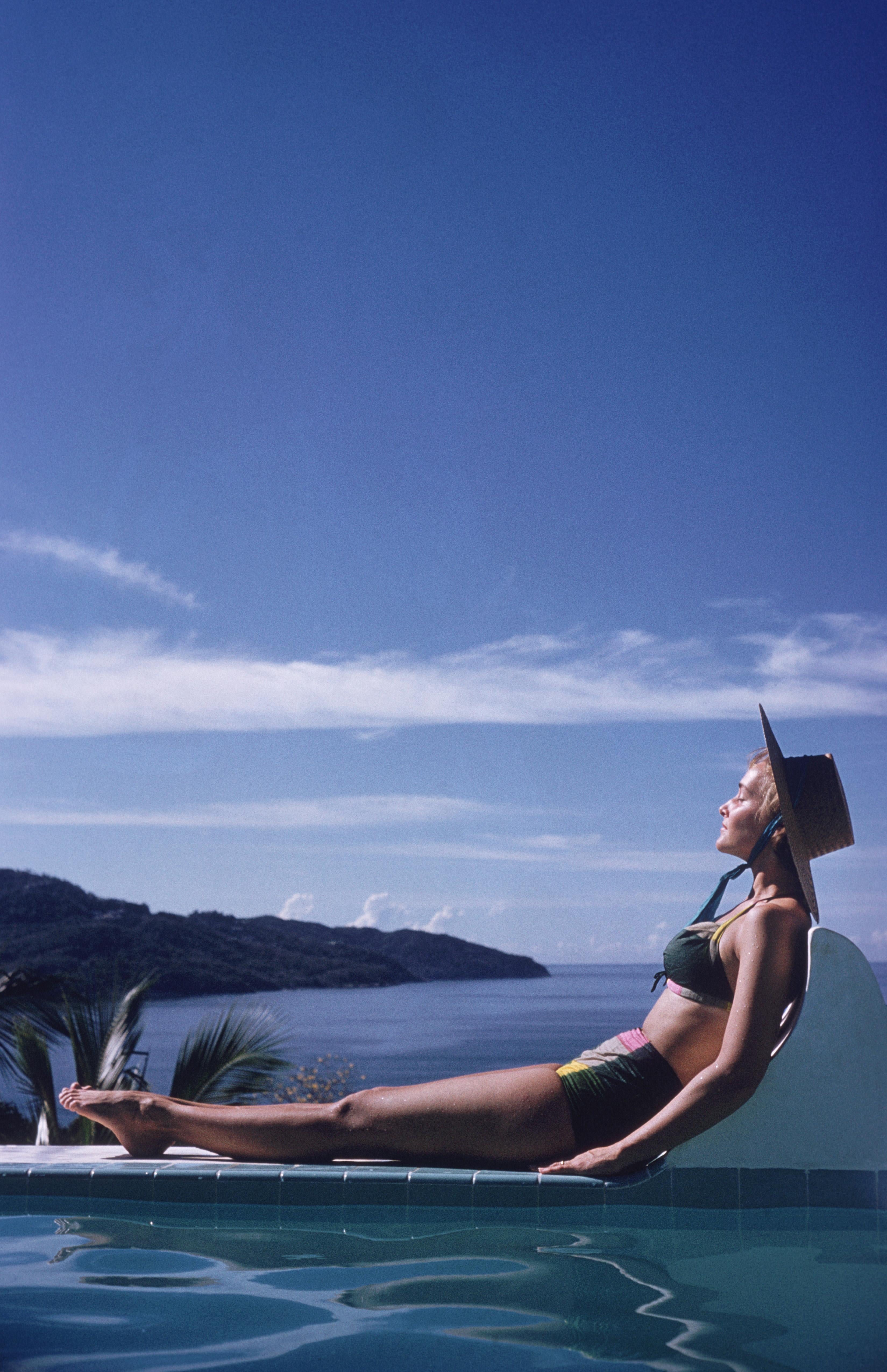Ingrid Morath sunbathes by a swimming pool next to the sea in Acapulco, 1961. Ingrid was born in Rio de Janeiro and lives in Mexico City.

Portofino Villa
Slim Aarons Estate Edition
Chromogenic Lambda print
Printed Later
Slim Aarons Estate