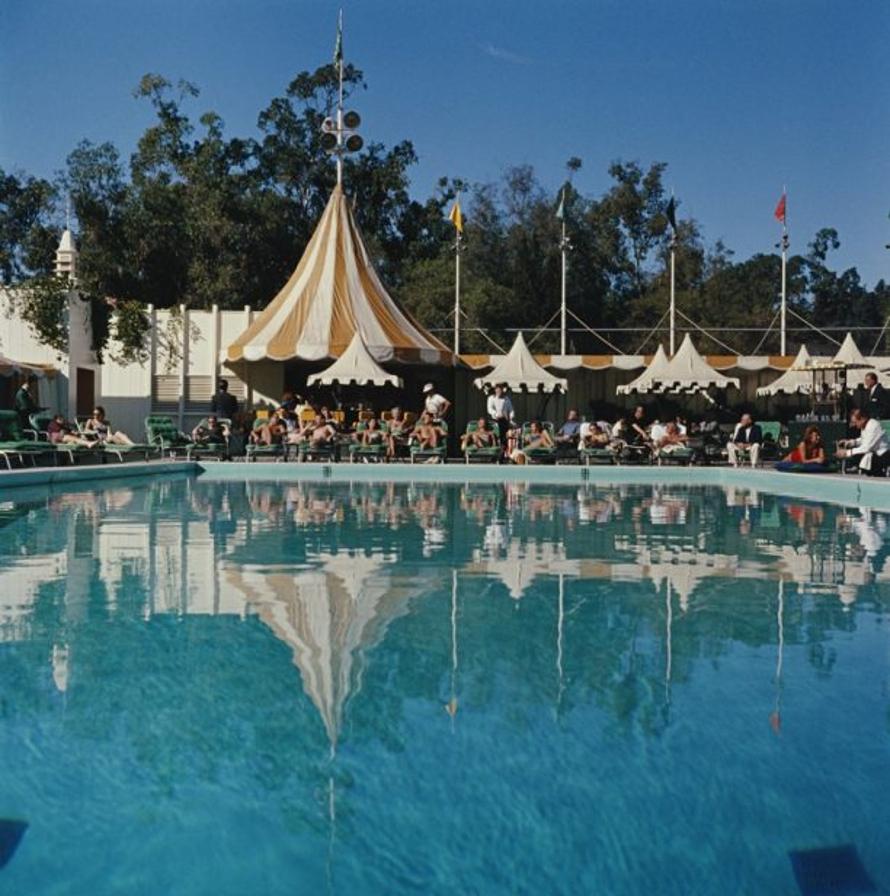 Beverly Hills Hotel 
1957
by Slim Aarons

Slim Aarons Limited Estate Edition

Holiday makers relaxing by the pool at the Beverly Hills Hotel on Sunset Boulevard in California, 1957. 

unframed
c type print
printed 2023
20 x 20"  - paper