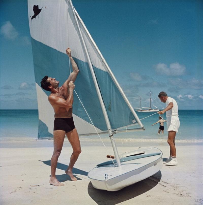 'Boating In Antigua' 1961 Slim Aarons Limited Estate Edition Print 

American actor Hugh O'Brian (left) hoists the sail on a dinghy, Antigua, West Indies, 1961. 
(Photo by Slim Aarons/Hulton Archive/Getty Images)

Produced from the original