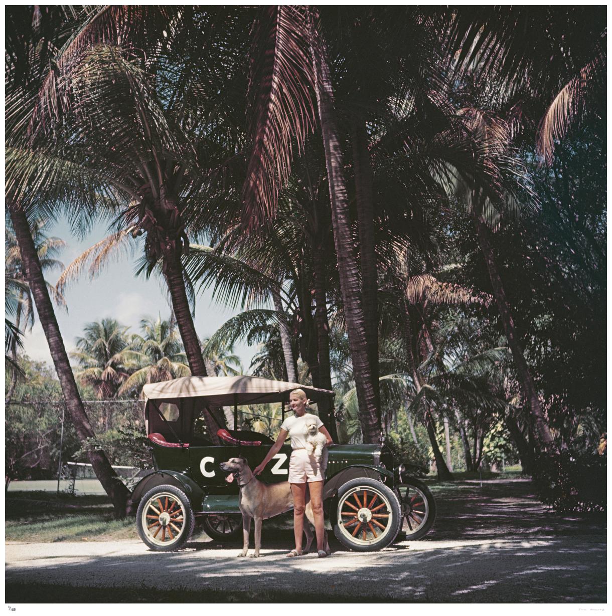 C Z And Friends 1955 - Slim Aarons

American socialite Mrs. Winston F. C. Guest (aka C. Z. Guest, 1920 – 2003) with her personalized Ford Model T tourer, in the company of a poodle and a Great Dane, Palm Beach, Florida, circa 1955.

20 x 20" inches