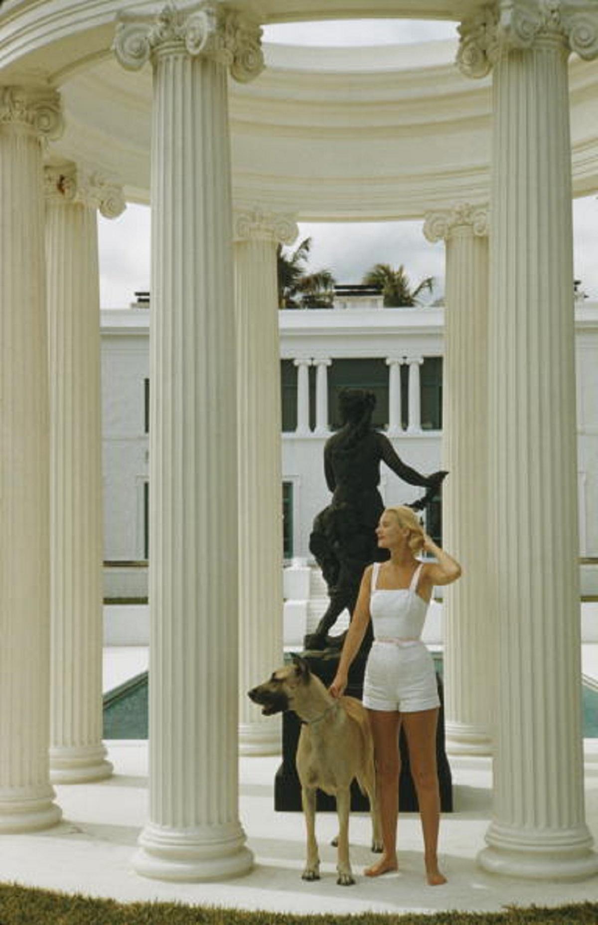 'C. Z. Guest' 1955 Slim Aarons Limited Estate Edition Print 

American socialite Mrs. Winston F. C. Guest (aka C. Z. Guest, 1920 - 2003) with a Great Dane at her ocean-front estate, Villa Artemis, in Palm Beach, Florida, 1955. 
(Photo by Slim