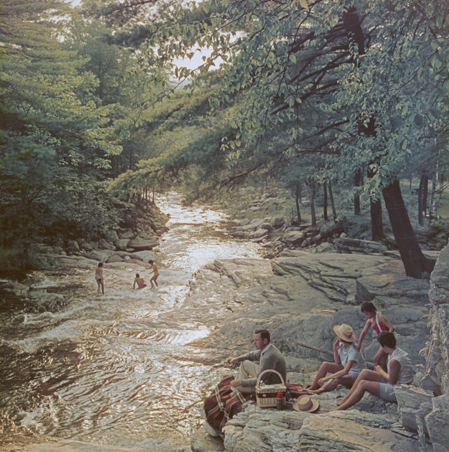 Campbell Falls Picnic 
1959
by Slim Aarons

Slim Aarons Limited Estate Edition

A family enjoying a picnic on the bank of the Whiting River near Campbell Falls, Massachusetts, USA, 1959. 

unframed
c type print
printed 2023
16×16 inches - paper