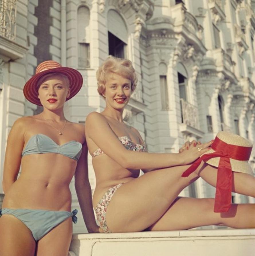Cannes Cannes Girls 
1958
by Slim Aarons

Slim Aarons Limited Estate Edition

 Two bikini-clad holidaymakers posing outside the Carlton Hotel in Cannes, in the south of France, 1958.

unframed
c type print
printed 2023
20 x 20"  - paper