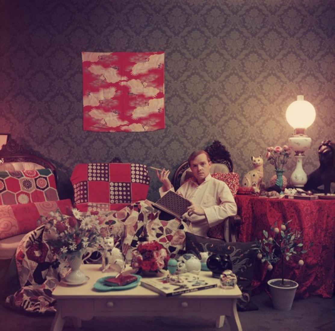 Capote At Home 
1958
by Slim Aarons

printed 2023

Slim Aarons Limited Estate Edition

Author Truman Capote (1924 – 1984) relaxes with a book and a cigarette in his cluttered apartment, Brooklyn Heights, New York. 1958.

unframed
c type

numbered in