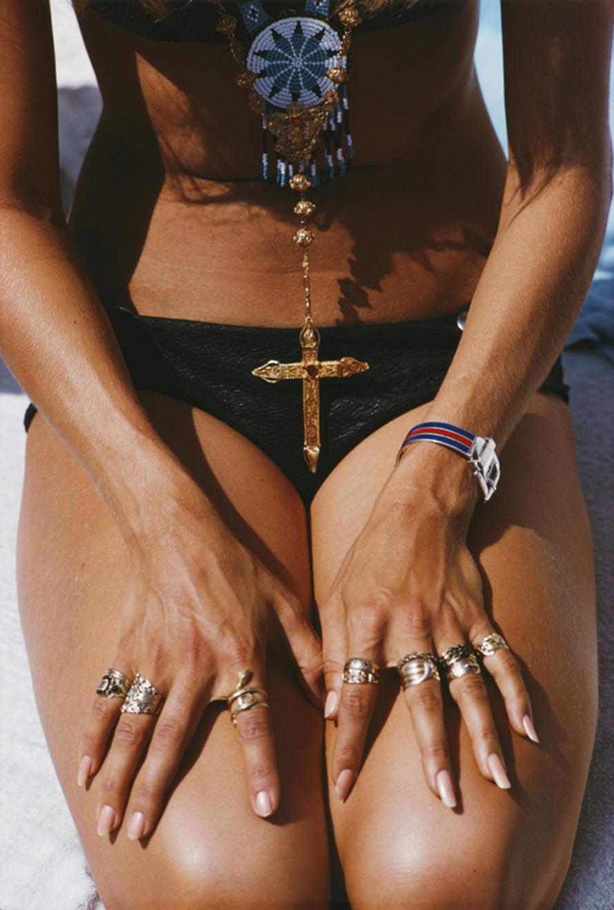 Capri Tan 
1968
by Slim Aarons

Slim Aarons Limited Estate Edition

1968, A kneeling sunbather shows off her rings and pendant on a beach in Capri, Italy

unframed
c type print
printed 2023
20 × 16 inches - paper size


Limited to 150 prints only –
