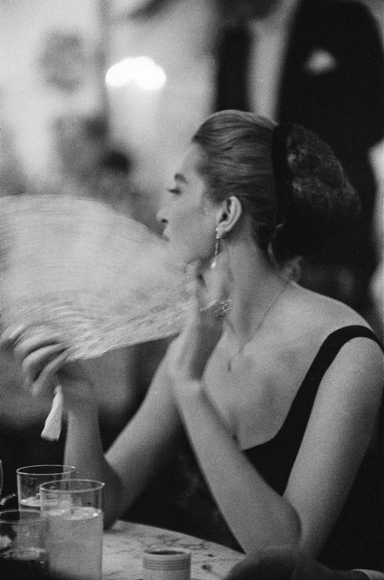 1957: French actress Capucine, (Germaine Lefebvre) (1933 - 1990) fanning herself at a New Years Eve party held at Romanoffs in Beverly Hills.

Signed in black archival ink on recto, bottom right. Numbered in black archival ink on recto, bottom left.