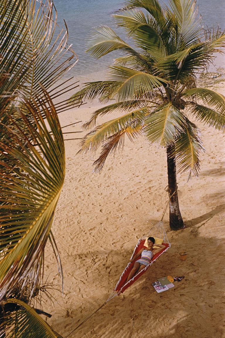 Caribe Hilton Beach, 1956
Chromogenic Lambda Print
Estate edition of 150

A woman reclining in a hammock hung between palm trees on the beach at the Caribe Hilton in San Juan, Puerto Rico, March 1956.

Estate stamped and hand numbered edition of 150