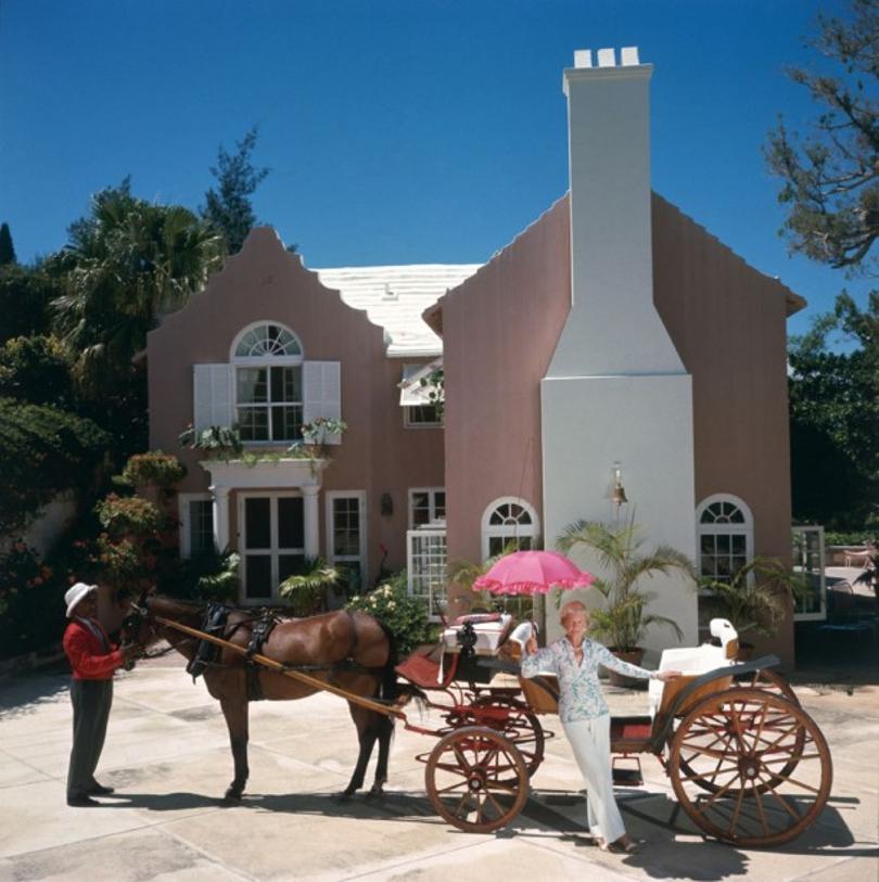 Carriage Awaits 
1977
by Slim Aarons

Slim Aarons Limited Estate Edition

Mrs Kenneth Appleton Ives with a horse and carriage outside her house in Bermuda, 1977.

unframed
c type print
printed 2023
16×16 inches - paper size


Limited to 150 prints