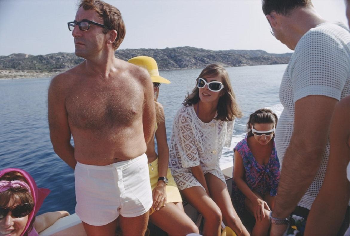 'Celebrity Cruise' 1965 Slim Aarons Limited Estate Edition Print 

circa 1965: British comedian Peter Sellers (1925 - 1980) holidays with Princess Margaret (1930 - 2002, right) on the Aga Khan's yacht on the Costa Smeralda. 

Produced from the