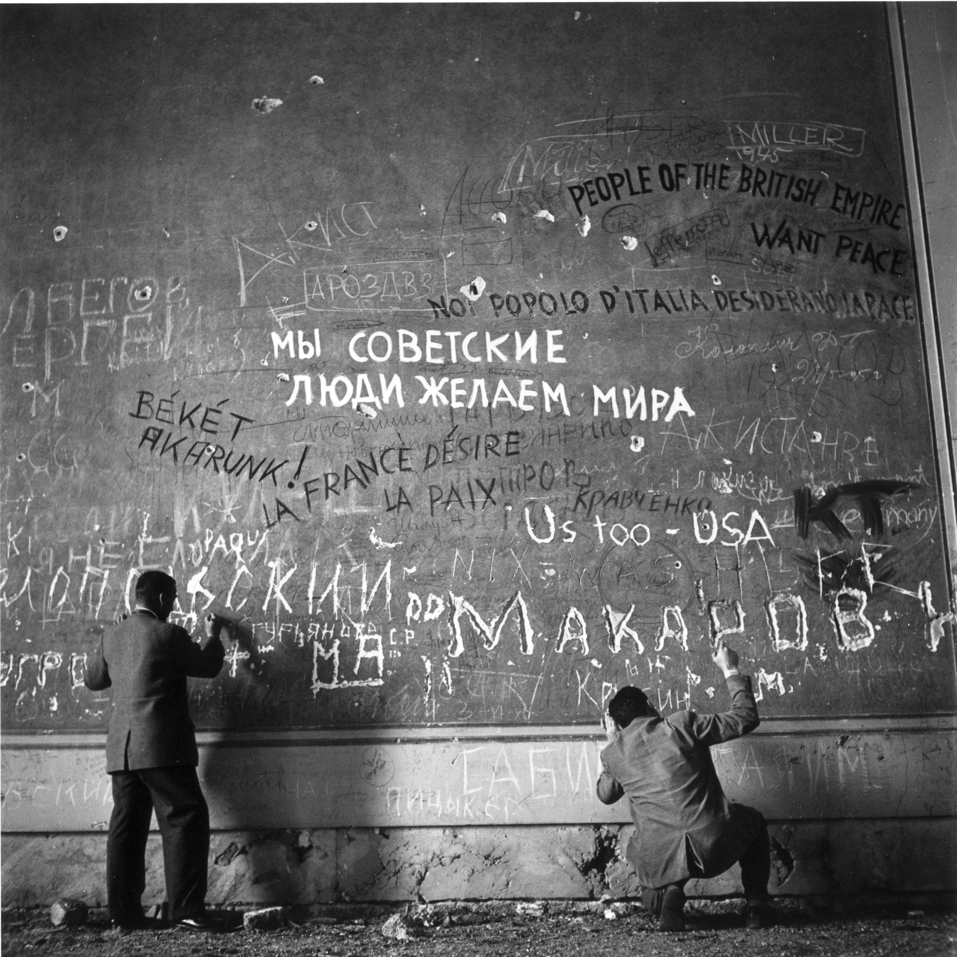 1945: Graffiti on the wall of Hitler's chancellery shortly after his death. The men are Life photographers Hank Walker and Charles Steinhern.

Signed in black ink on recto, bottom right. Numbered in black ink on recto, bottom left. Printed from