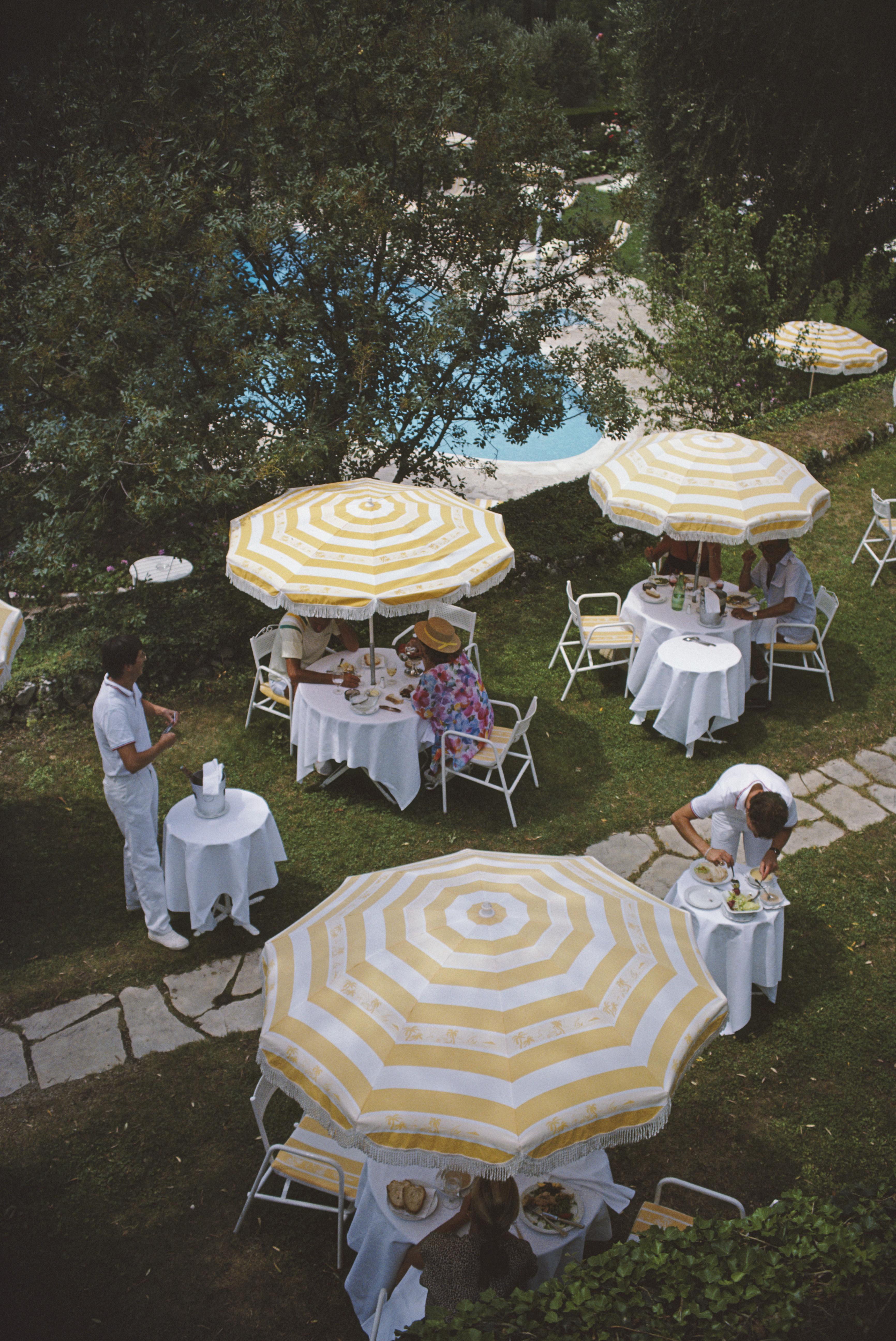 'Chateau Saint-Martin' 1986 Slim Aarons Limited Estate Edition Print 

An outdoor luncheon by the swimming pool of the Chateau Saint-Martin, a luxury hotel in Vence on the Cote d'Azur, France, 1986. The building was once a Commanderie of the Knights