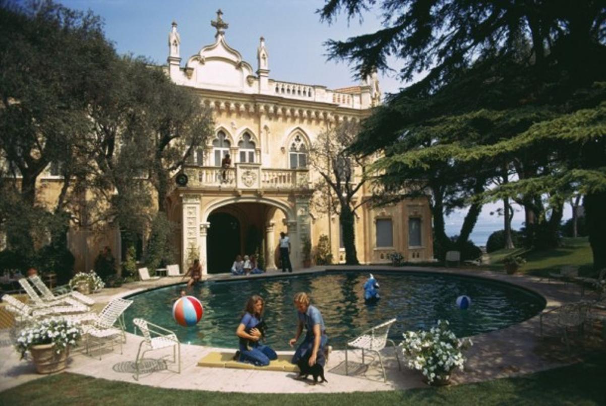 Chateau St. Jean 
1973
by Slim Aarons

Slim Aarons Limited Estate Edition

Guests around the pool at the Chateau St. Jean, owned by Rosemarie Kanzler Marcie Riviere, Cap Ferrat, France, September 1973.

unframed
c type print
printed 2023
16 x 20" -
