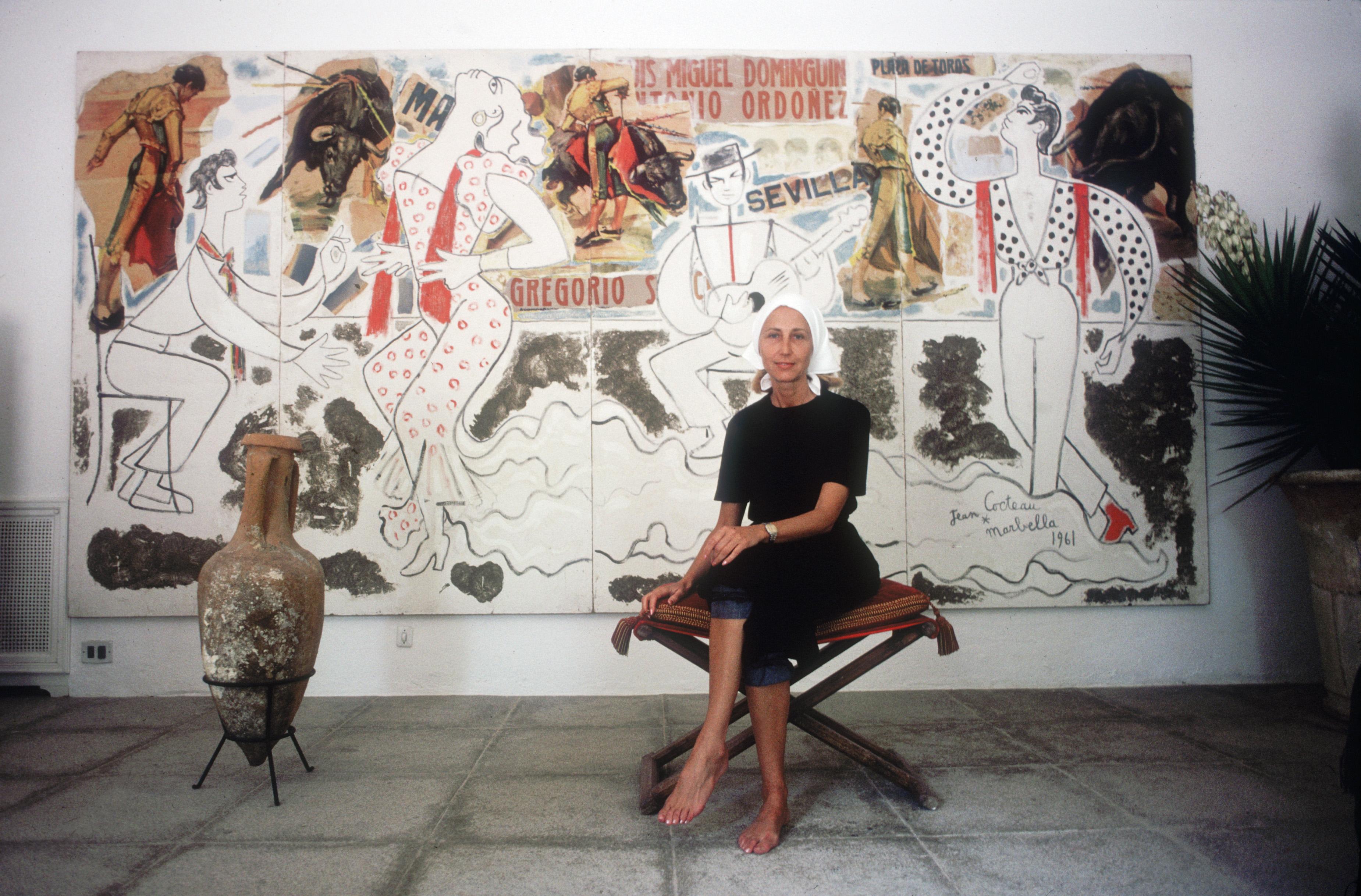 August 1982: Art collector Sylvia Coca sits in front of one of Jean Cocteau's murals in Marbella. (Photo by Slim Aarons/Getty Images)

Slim Aarons Estate Edition, Certificate of Authenticity included
Numbered and stamped by the Slim Aarons