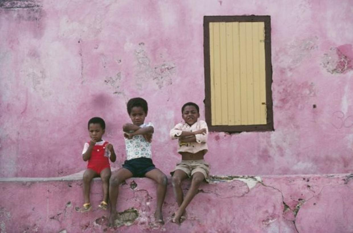 Curacao Children 
1979
by Slim Aarons

Slim Aarons Limited Estate Edition

Three local children sitting on a low wall, Curacao, Netherlands Antilles, January 1979.

unframed
c type print
printed 2023
20 x 24"  - paper size

Limited to 150 prints