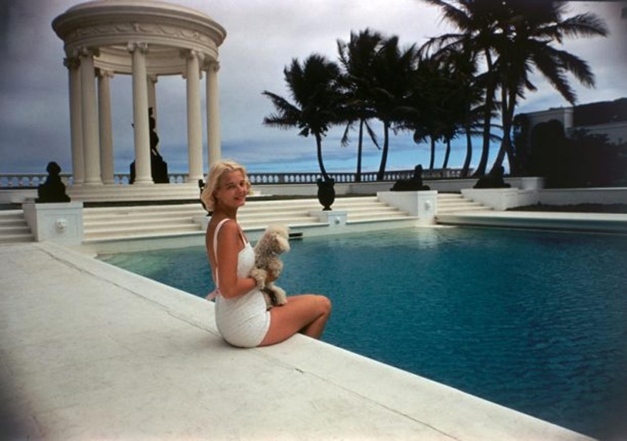CZ by the Pool 
1955
by Slim Aarons

Slim Aarons Limited Estate Edition

American socialite Mrs. Winston F. C. Guest (aka CZ Guest, 1920 – 2003) perches on the edge of the Grecian temple pool on her ocean-front estate, Villa Artemis, Palm Beach,