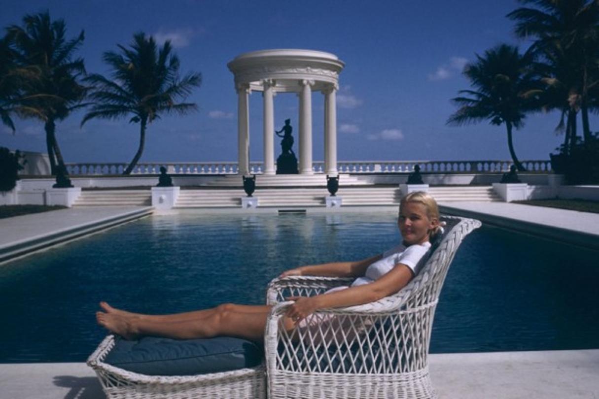 CZ’s House 
1955
by Slim Aarons

Slim Aarons Limited Estate Edition

1955: Mrs F C Winston Guest (1920 – 2003) (aka Cee Zee Guest) reclines on a garden chair in front of the Grecian temple pool on her ocean-front estate, Villa Artemis, Palm Beach,